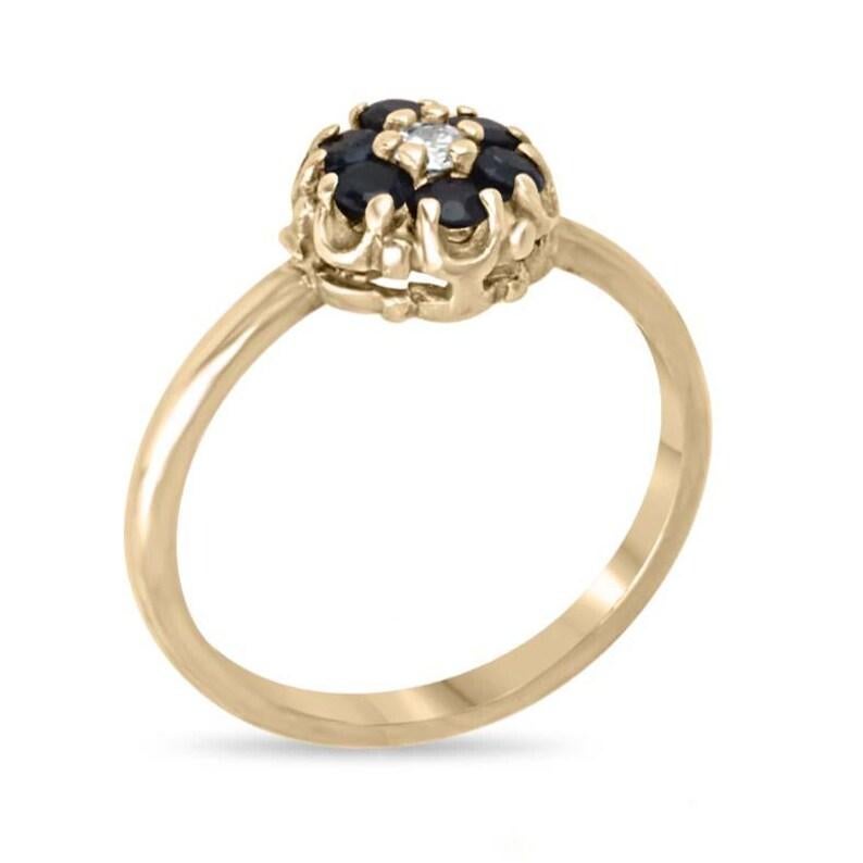 This vintage natural sapphire and diamond cocktail ring is handcrafted from solid 14K yellow gold, featuring genuine round-cut blue sapphires of good quality. The sapphires are beautifully complemented by natural white diamonds, prong-set to enhance