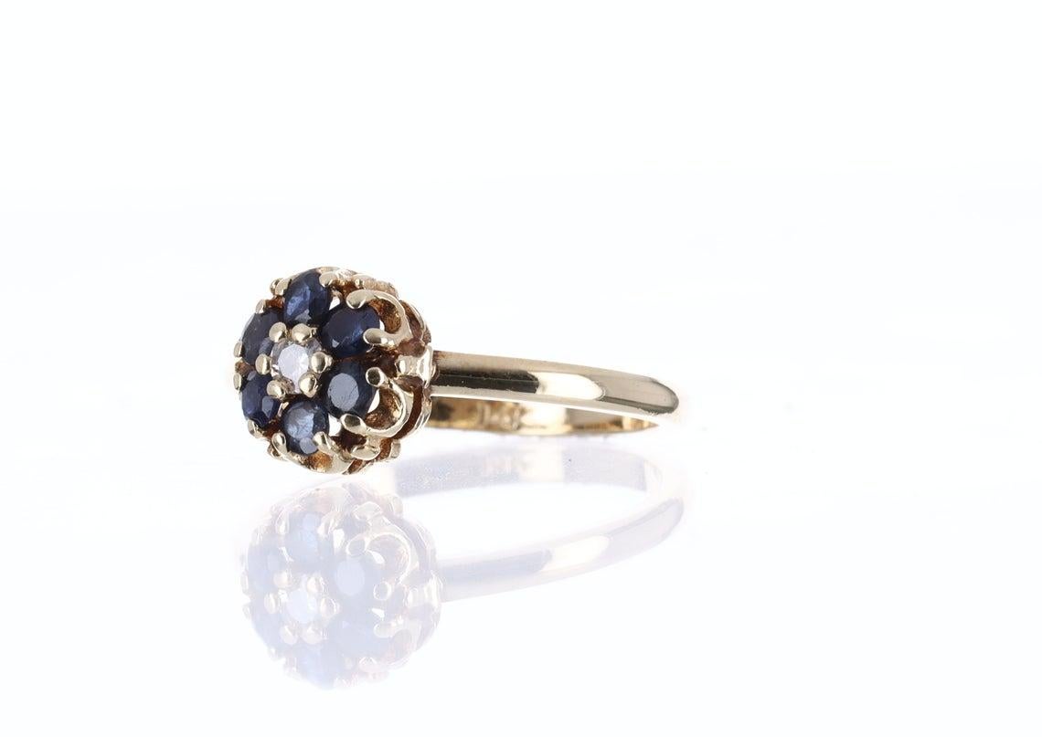 0.32 TCW Vintage 14K Yellow Gold Natural Genuine Blue Sapphire & Diamonds Cocktail Ring. The piece was hand made with solid yellow gold. The round shape sapphires are 100% genuine with good qualities. Accenting the beautiful sapphires are natural