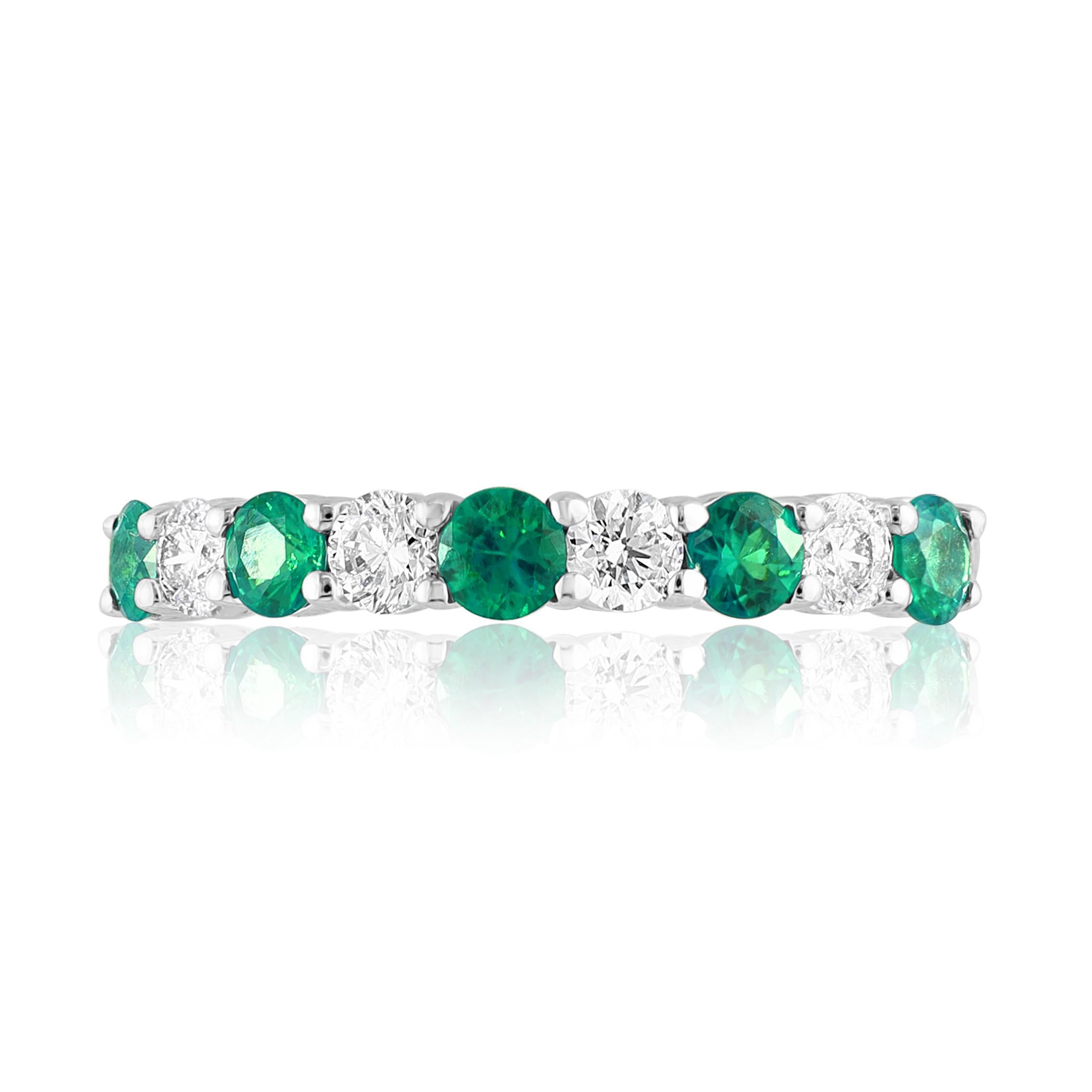 A fashionable and classic wedding band showcasing 4 brilliant cut diamonds weighing 0.37 carats total alternating with 5 round emeralds weighing 0.33 carats. Stones secured with a shared 4 prong setting made with 14K white gold. A versatile piece