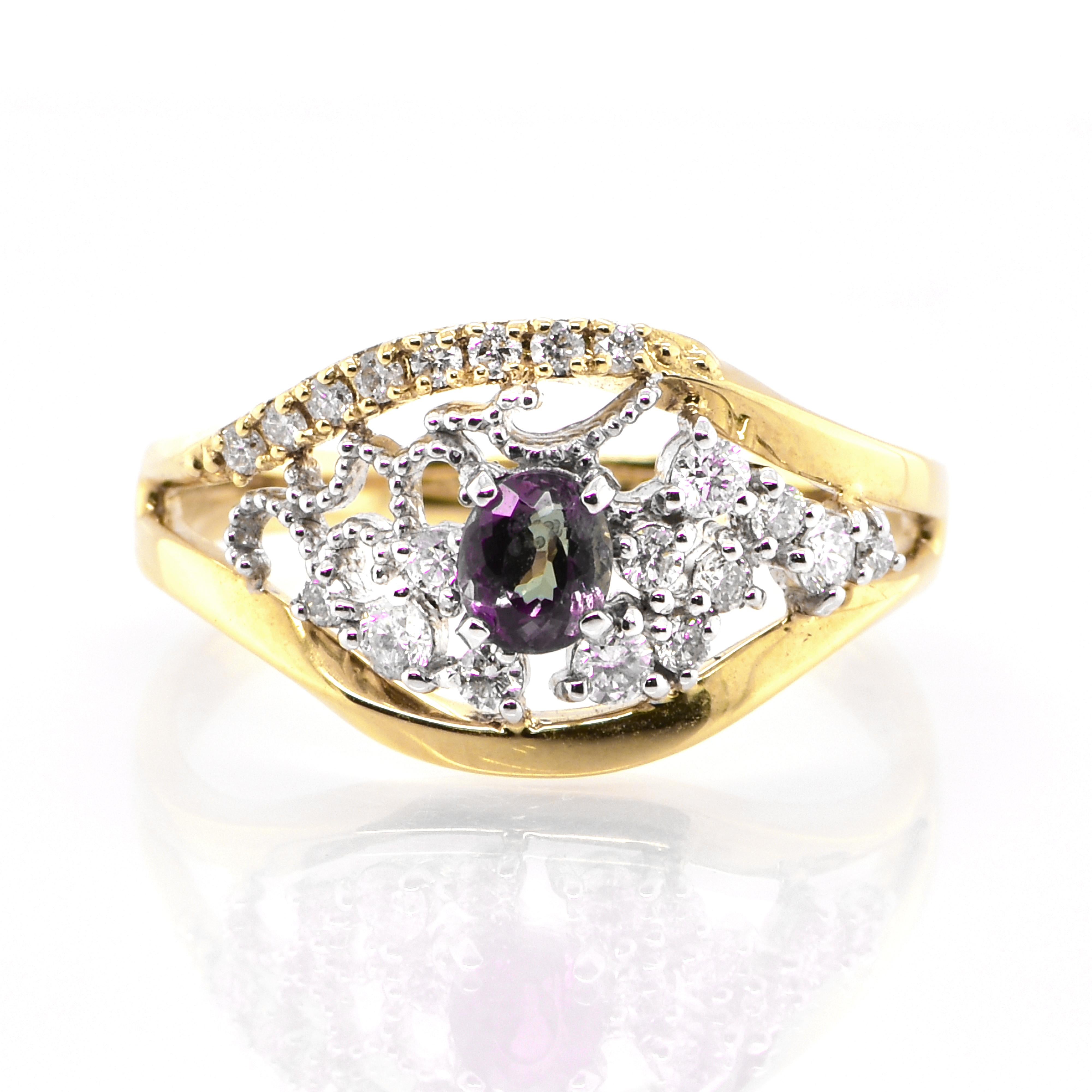 A gorgeous ring featuring 0.33 Carat, Natural Alexandrite and 0.27 Carats of Diamond Accents set in 18 Karat Yellow Gold and Platinum Alexandrites produce a natural color-change phenomenon as they exhibit a Bluish Green Color under Fluorescent Light