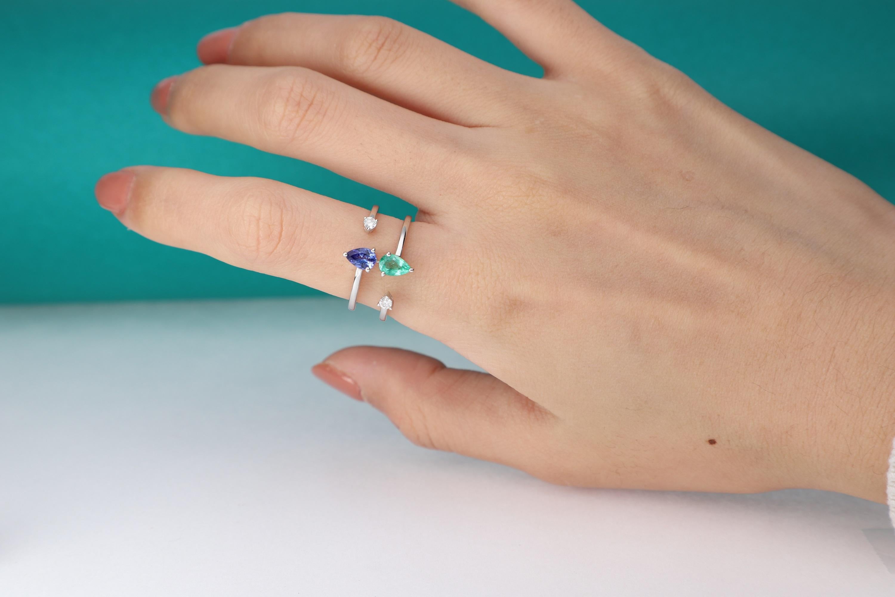 This beautiful Natural Emerald and Tanzanite Ring is crafted in 14-karat White gold and features a 0.42 carat 1 Pc Tanzanite and 1pc. 0.33 ct. Emerald with 2Pcs Round White Diamonds in GH- I1 quality with 0.13 Ct in a prong-setting. 
This Ring comes