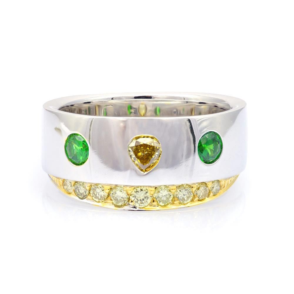 Crafted in 14K white gold, this wedding band has the perfect burst of color it needs. With the bright yellow from a well-matched selection of diamonds to the fresh renewing colors of the rare 0.33 carat Russian Demantoid garnets, this ring will make