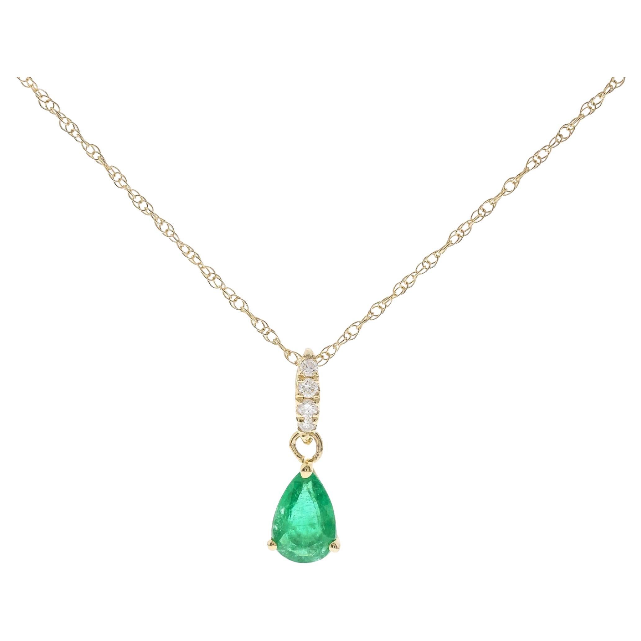 0.33 Carat Pear Cut Emerald with Diamond Accents 10K Yellow Gold Pendant