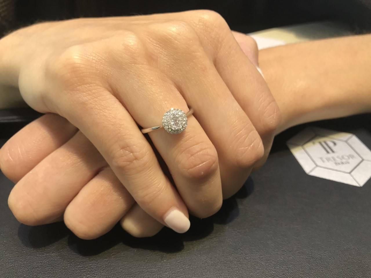 This Beautiful 0.33 Carat White Round Cut Diamond Cluster Halo ring is set in 18 Karat White Gold and color H clarity SI1. Ring size UK - M, US - 6 1/2. Available in other carat sizes as well as ring sizes. British hallmarked by the London Assay