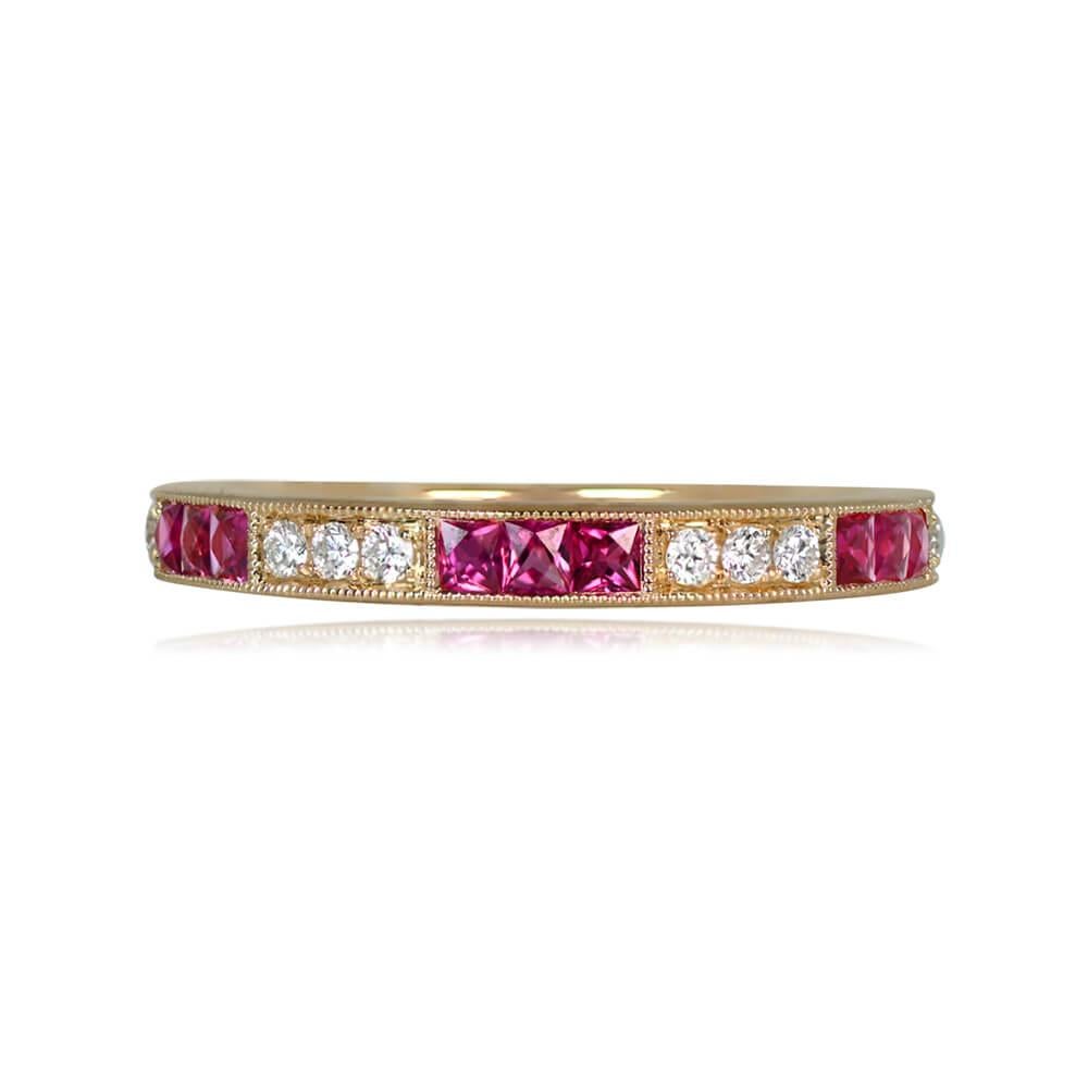 A captivating half-eternity wedding band handcrafted in 18k yellow gold, featuring French cut rubies totaling 0.33 carats channel-set between round brilliant cut diamonds with a total weight of 0.14 carats. The diamonds are held in prongs inside