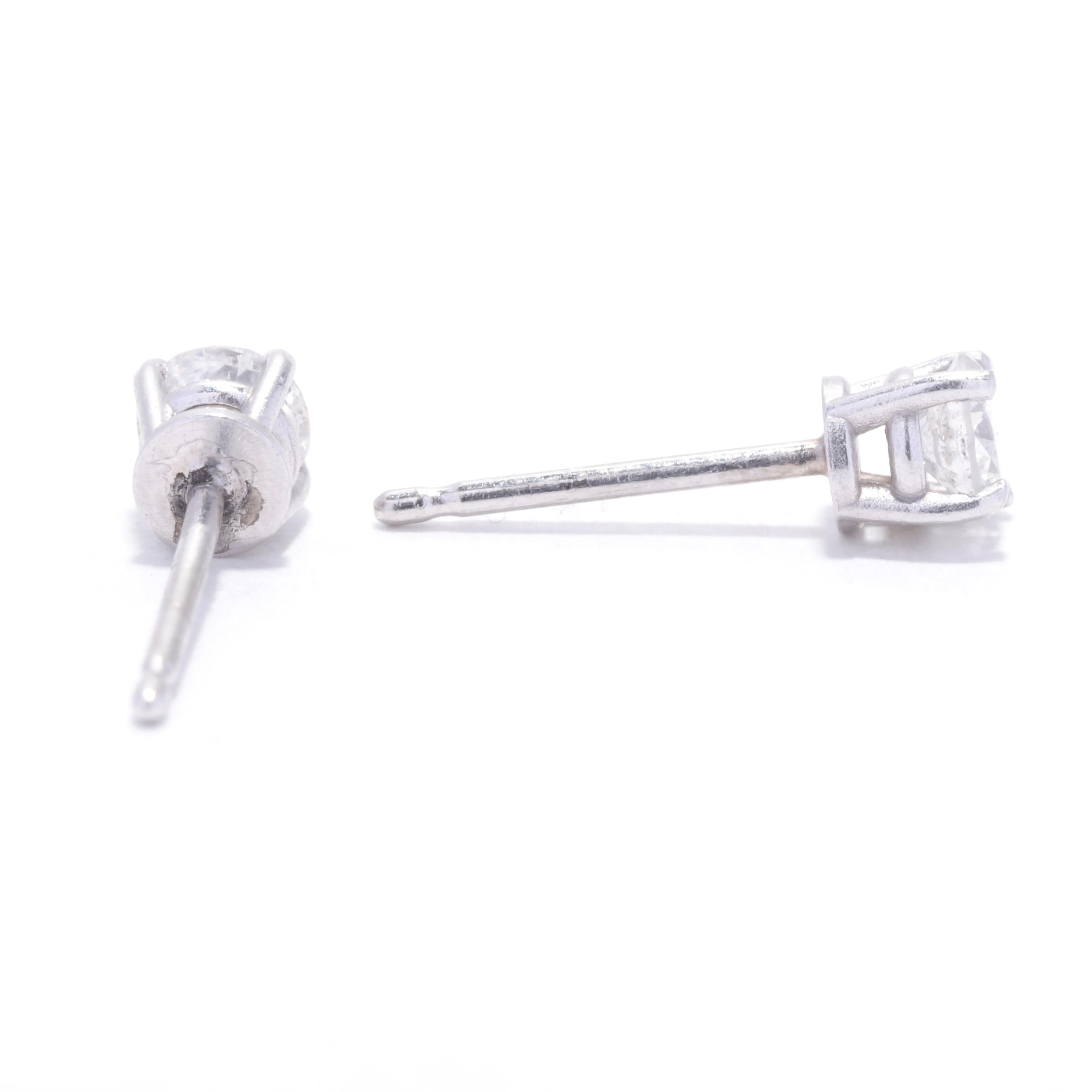 A pair of 14 karat white gold diamond stud earrings. This simple stud earrings feature prong set, round brilliant cut diamonds weighing approximately .33 total carats with pierced push backs.

Stones: 
- diamonds, 2 stones
- round brilliant cut
-