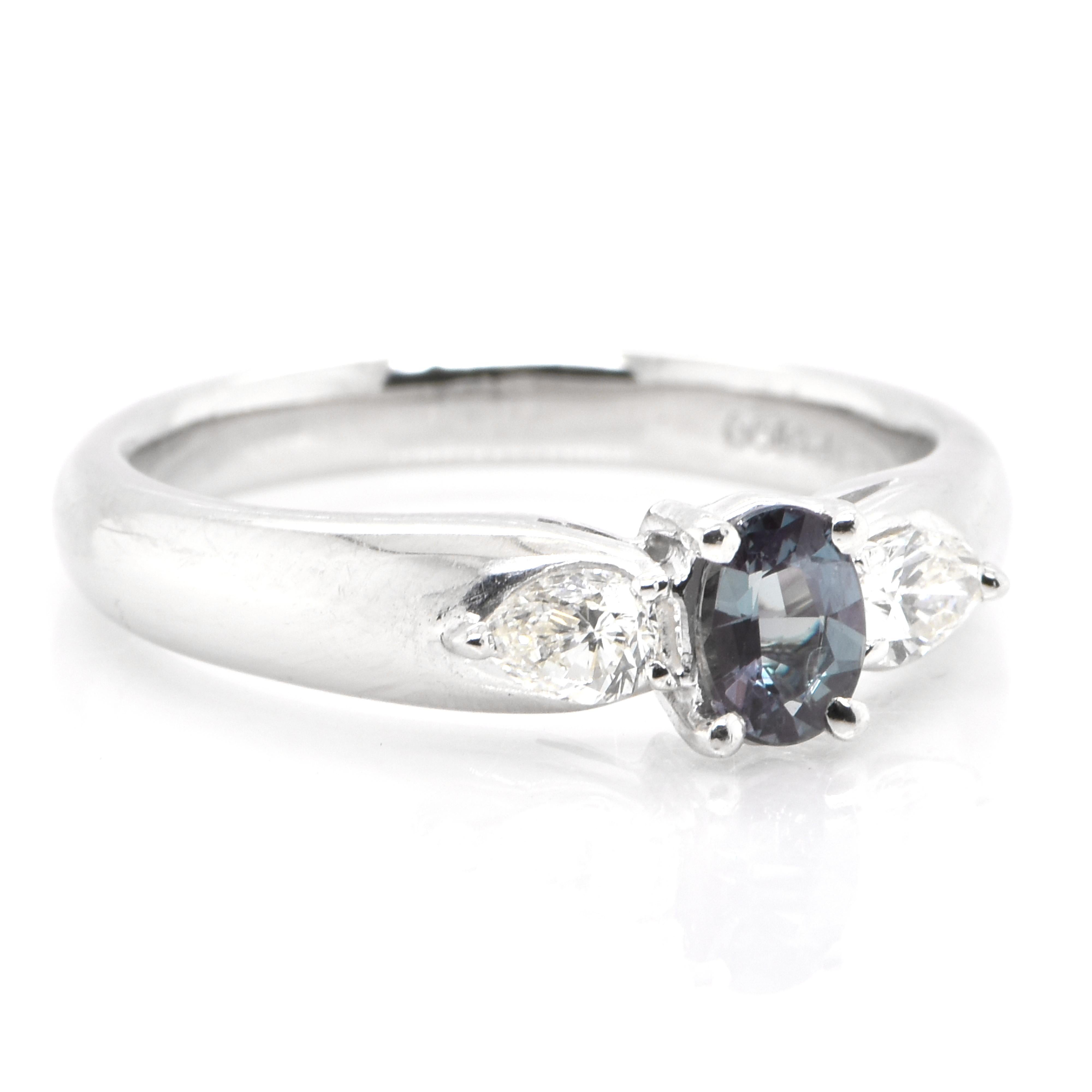 A gorgeous ring featuring a 0.34 Carat, Natural Alexandrite and 0.30 Carats of Diamond Accents set in Platinum. Alexandrites produce a natural color-change phenomenon as they exhibit a Bluish Green Color under Fluorescent Light whereas a Purplish