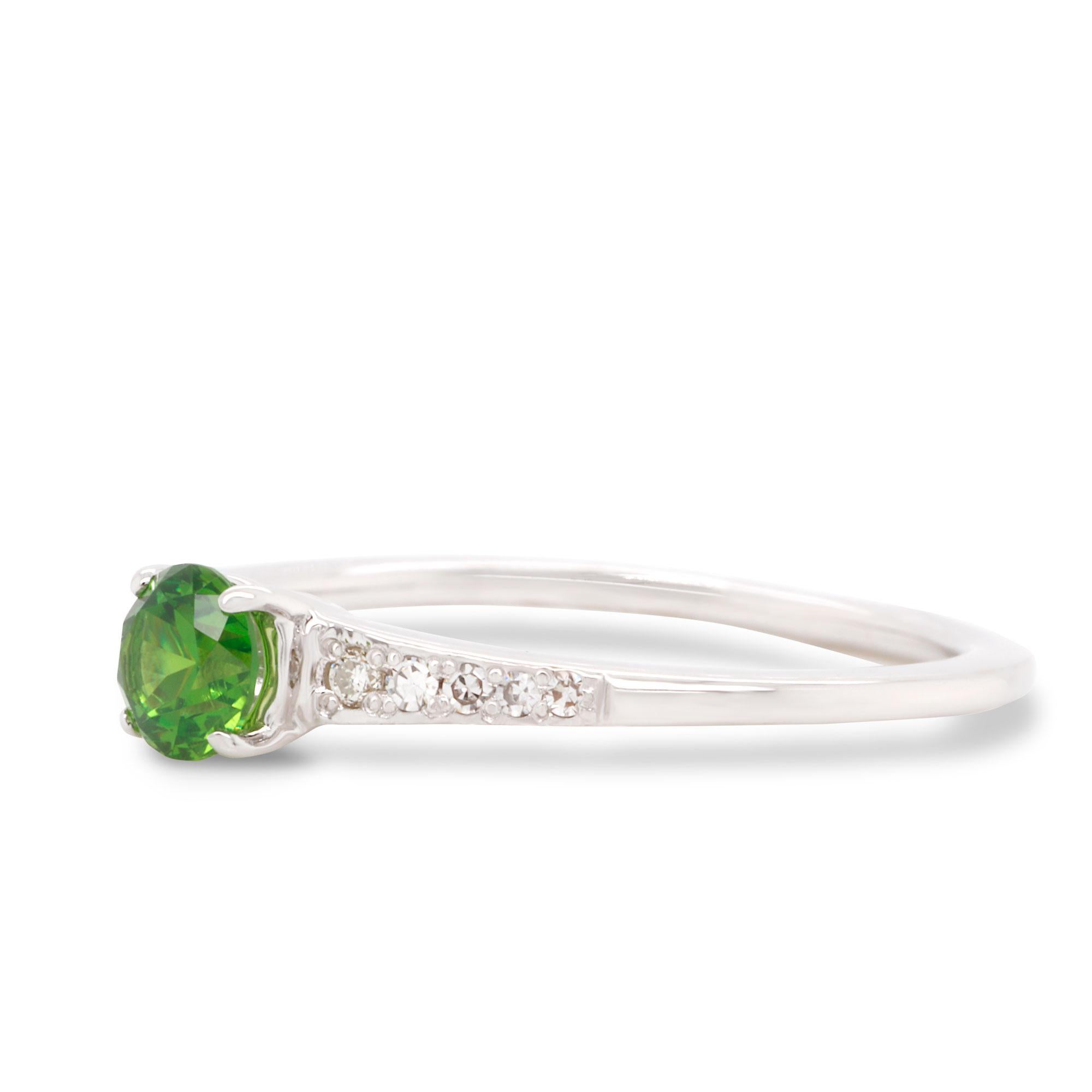 This is a classic 14K White Gold Ring with Diamonds. Center stone is a unique and rare Russian Demantoid 0.34 ct combined with white Diamonds totalling 0.052 ct. Perfect as for special occasion as for everyday wear, it can be used as wedding or