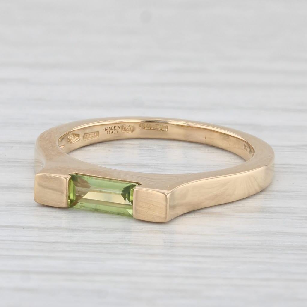 Gemstone Information:
- Natural Peridot -
Carats - 0.34ct
Cut - Rectangle
Color - Light Green

Metal: 18k Yellow Gold
Weight: 4.9 Grams 
Stamps: 750 Asprey Aldn Made in Italy 750
Face Height: 3 mm 
Rise Above Finger: 5 mm
Band / Shank Width: 2