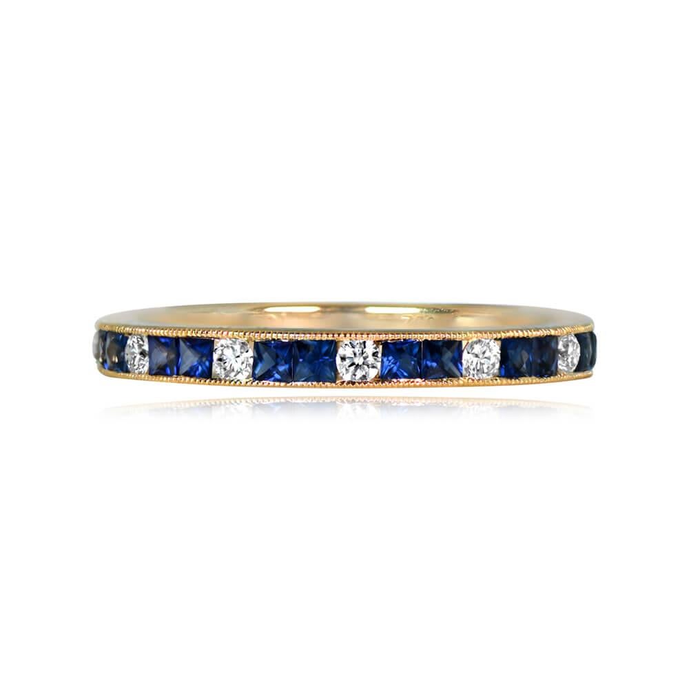 An exquisite half-eternity wedding band crafted in 18k yellow gold, showcasing channel-set French-cut sapphires with a total weight of 0.34 carats and round brilliant-cut diamonds weighing 0.16 carats. Delicate fine milgrain detailing enhances the