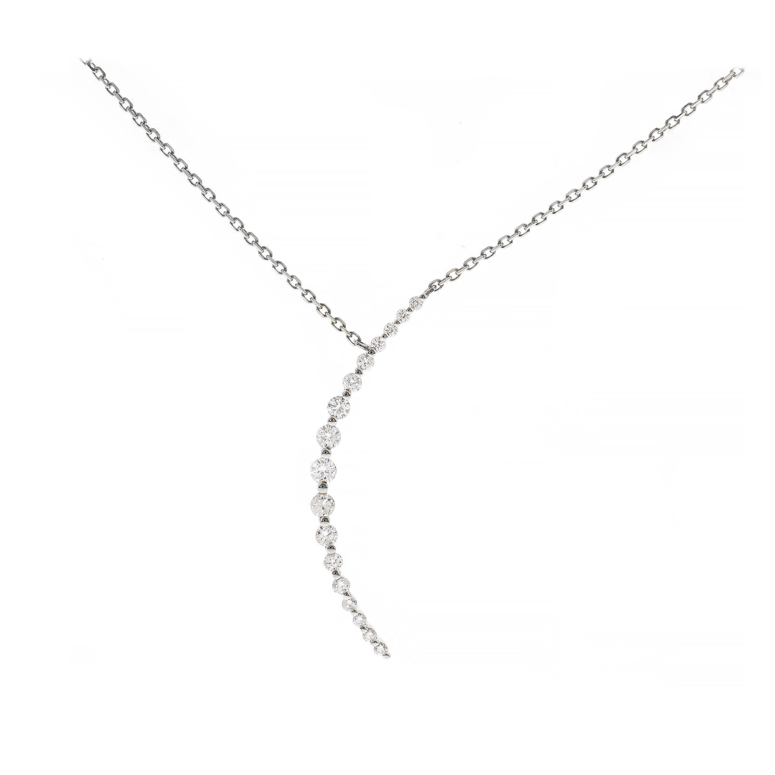 This modern Diamond Pendant features 17 shimmering white diamonds each dazzling with a memorable sparkle and fire that glimmer at light at every angle as they surround. This pendant is crafted of 14k white gold and drops 18