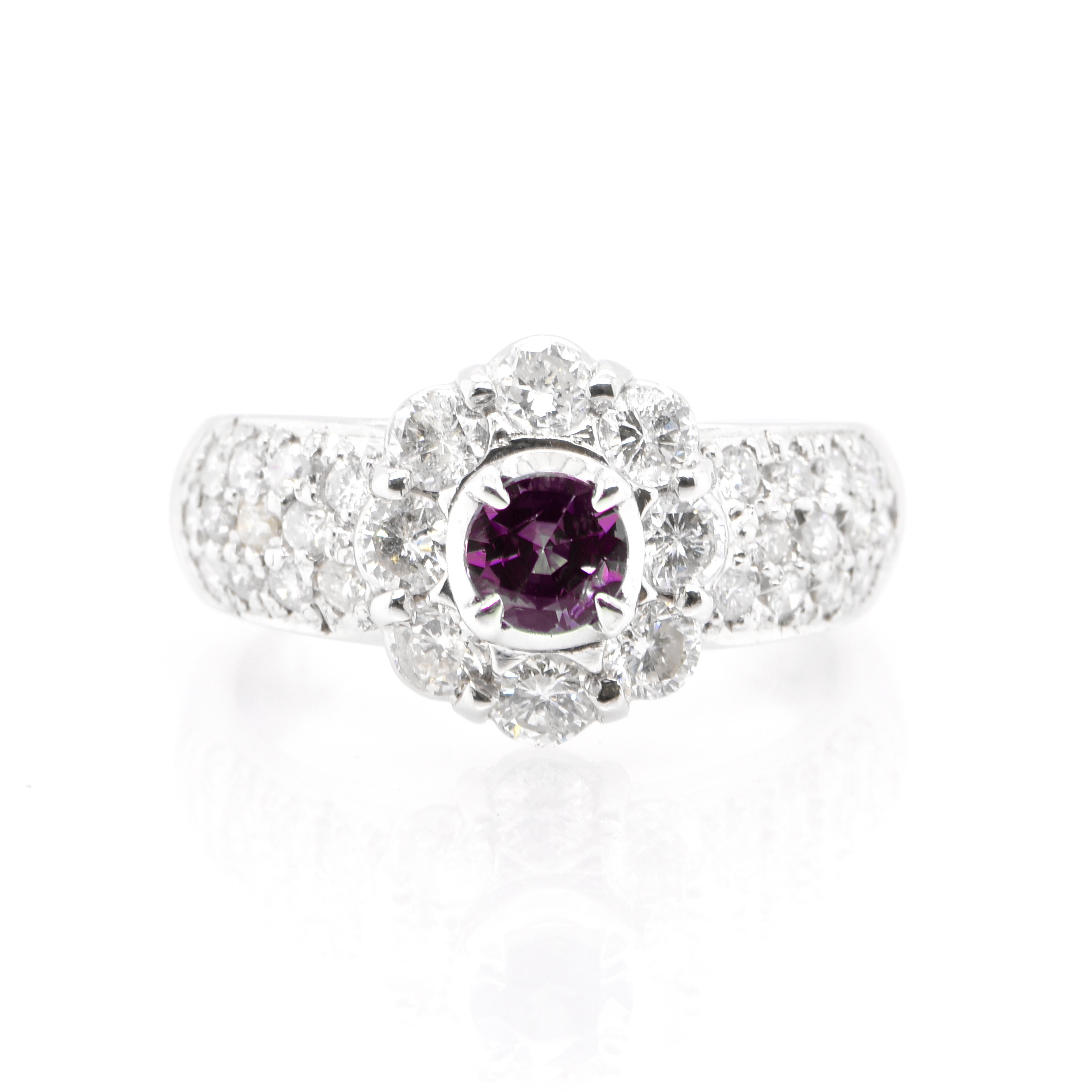 A beautiful 0.35 Carat, Natural, Round Alexandrite Ring with 1.05 Carats of White Round Brilliant Diamond Accents set in Platinum. Alexandrites produce a natural color-change phenomenon as they exhibit a Bluish Green Color under Fluorescent Light