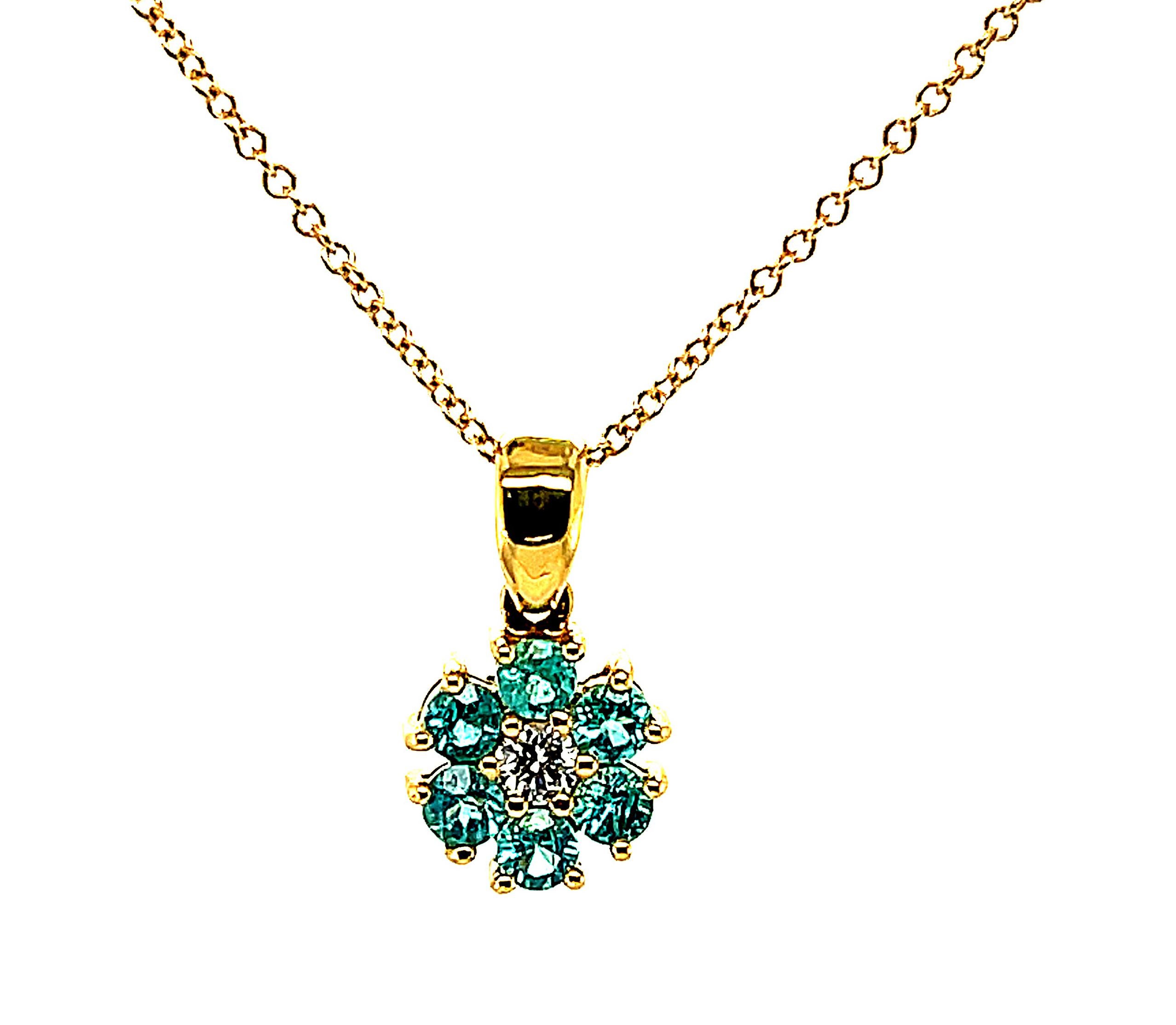 This delicate 18k yellow gold floral pendant is set with six Paraiba tourmalines with striking peacock blue color! Paraiba tourmalines are extremely rare, as they contain copper and manganese which give this variety their wonderfully vibrant and
