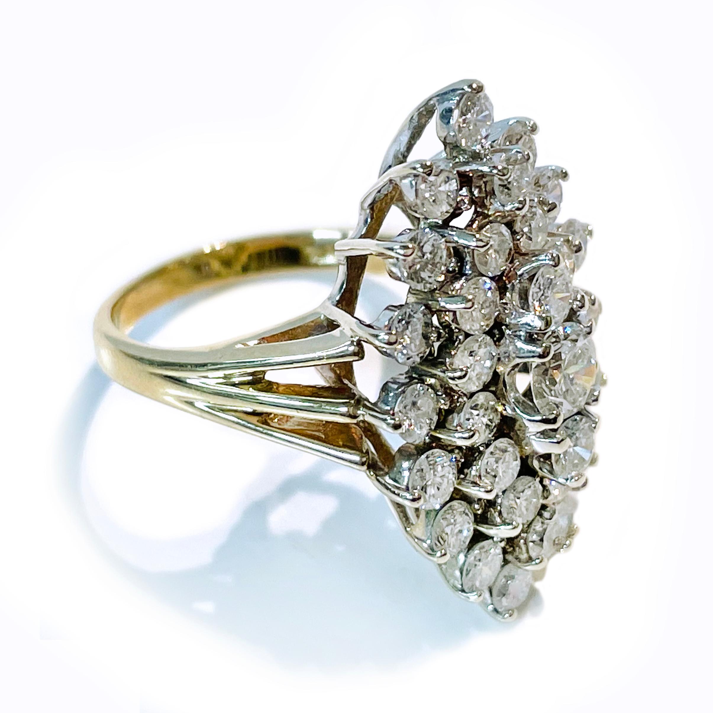 14 Karat Two-Tone Diamond Cluster Ring. The super sparkly ring features a split band and thirty-three brilliant-cut round diamonds. The multi-tiered raised gallery highlights the marquise-shaped formation of the stones. The diamonds range in size