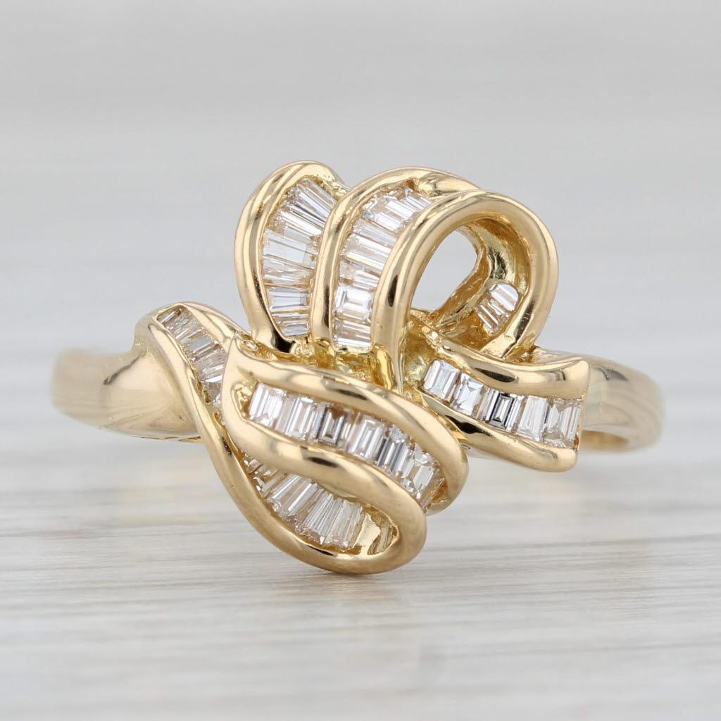 Gemstone Information:
- Natural Diamonds -
Total Carats - 0.35ctw
Cut - Baguette
Color - F - H
Clarity - VS2

Metal: 18k Yellow Gold 
Weight: 5.7 Grams 
Stamps: 750
Face Height: 14.2 mm 
Rise Above Finger: 7.9 mm
Band / Shank Width: 2.1 mm

This