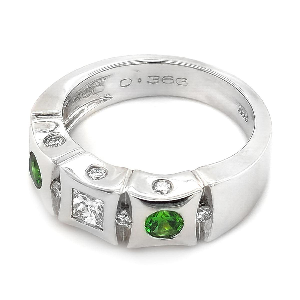 Mined in Russia, these Demantoid garnets set with diamond accents add a dazzling effect. Demantoid garnets are one of the rarest garnet varieties that boast a durability and vivid color. This 14K white gold band s et with two perfectly matched lush