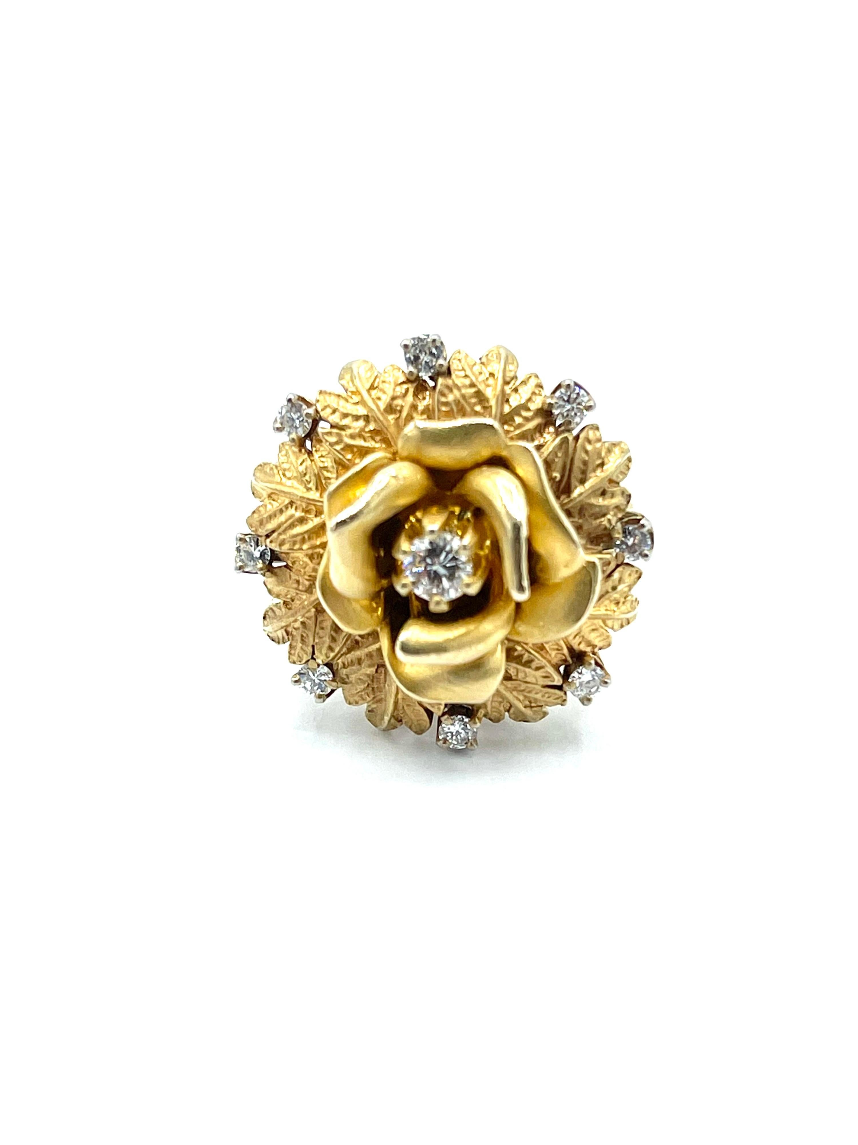 A whimsical Diamond flower cocktail ring!  The center Diamond is set with six prongs in the center of a blossoming flower, with eight more round brilliant cut Diamonds around the outside foliage.  The nine Diamonds have a total weight of .36 carats,