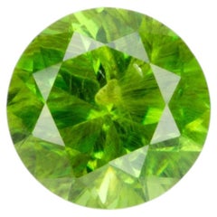 0.36 ct, Faceted Russian demantoid garnet with horsetail inclusion