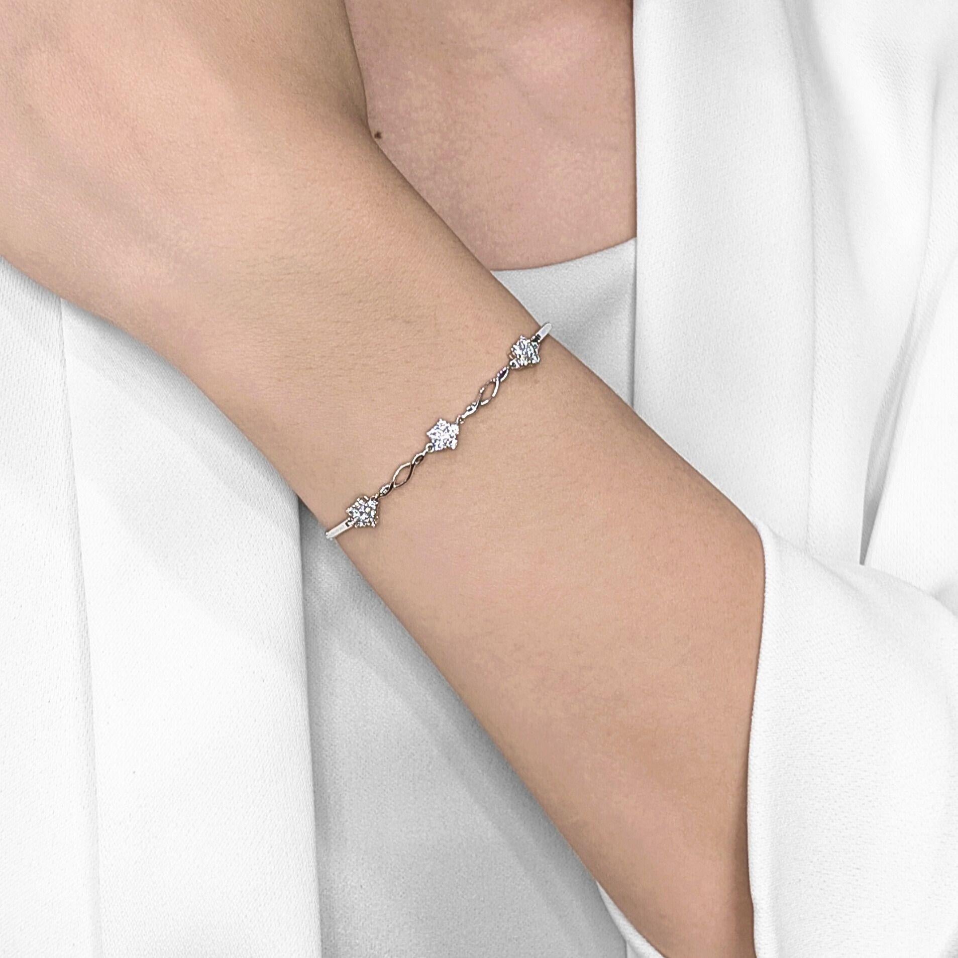 Charming and graceful, this dainty bracelet is adorned with 18 round brilliant natural diamonds totaling 0.36 carats, set in radiant 18K white gold. The design features sparkling star-shaped clusters linked by an elegant twist pattern, creating a