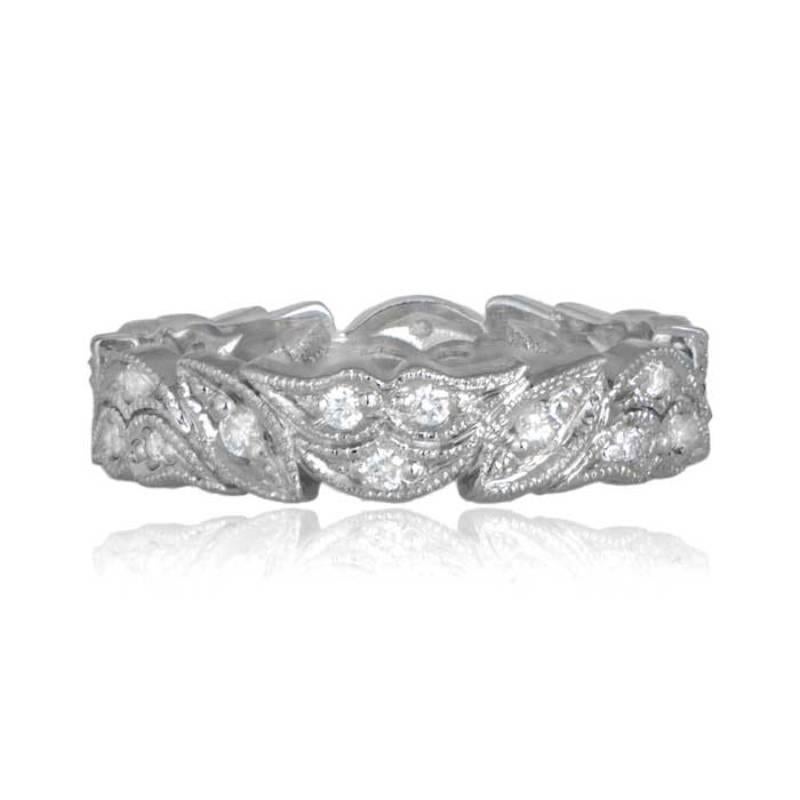A captivating platinum wedding band features a breathtaking floral motif, enhanced by approximately 0.36 carats of round brilliant cut diamonds. The diamonds, with H color and VS clarity, are meticulously set in an eternity setting. The band,