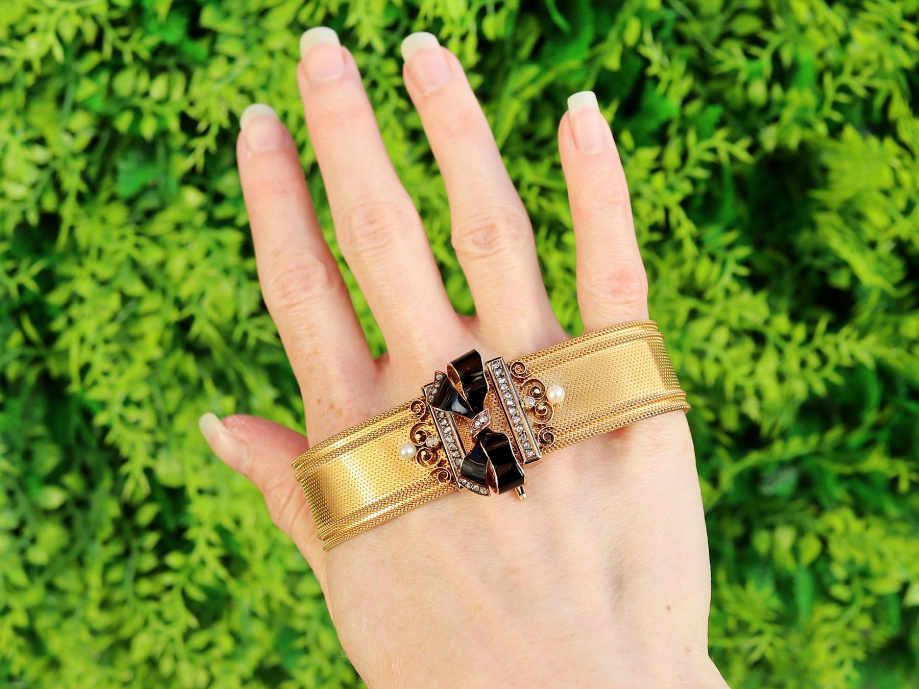 A stunning, fine and impressive antique 0.38 carat diamond, pearl and enamel, 18 karat yellow gold bracelet/brooch; part of our diverse antique Victorian jewelry collections.

This stunning antique Victorian bracelet has been crafted in 18k yellow