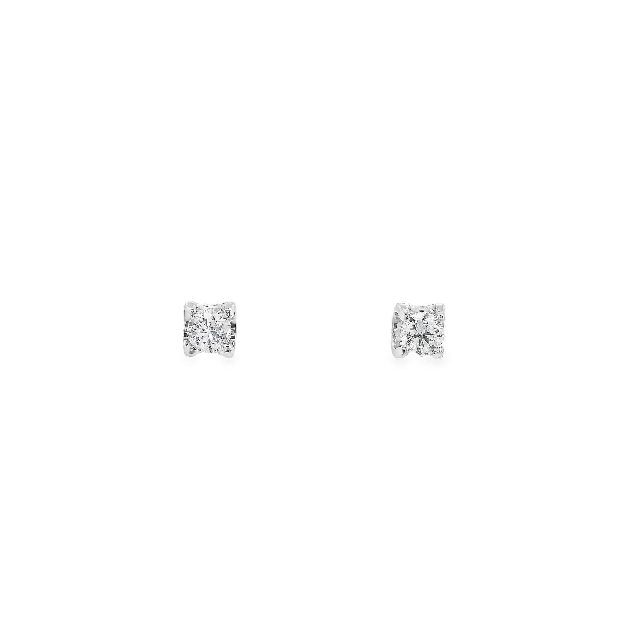 These elegant diamond stud earrings are the epitome of understated luxury. Featuring a large central round brilliant cut diamond that weighs 0.38 carats altogether, it catches the light beautifully. Crafted from high-quality 18K white gold weighing
