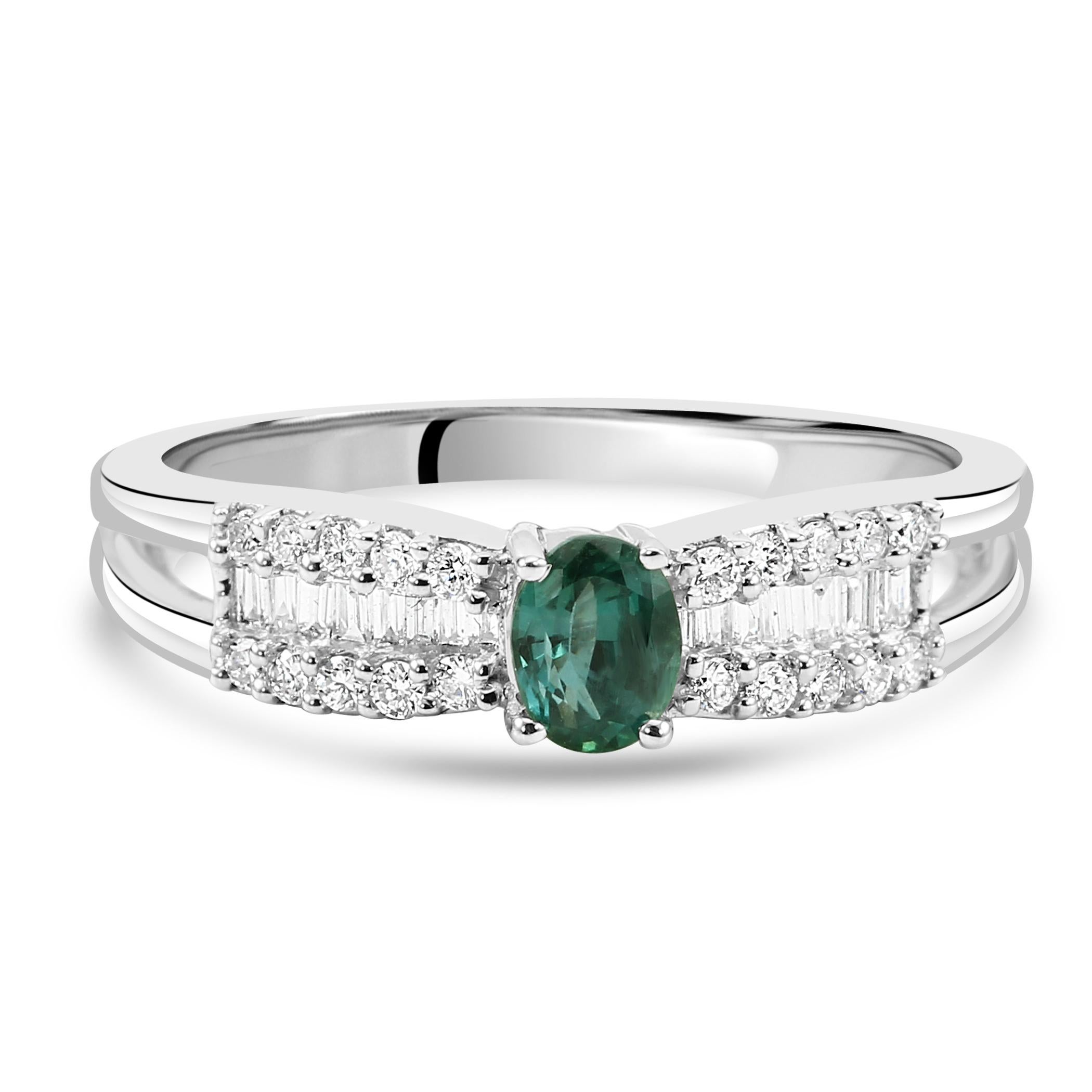 At the heart of this exquisite ring lies a captivating Alexandrite oval, chosen for its remarkable color-changing properties. With a weight of 0.39 carats, this Alexandrite's magnificent lush green hues creates an enchanting visual