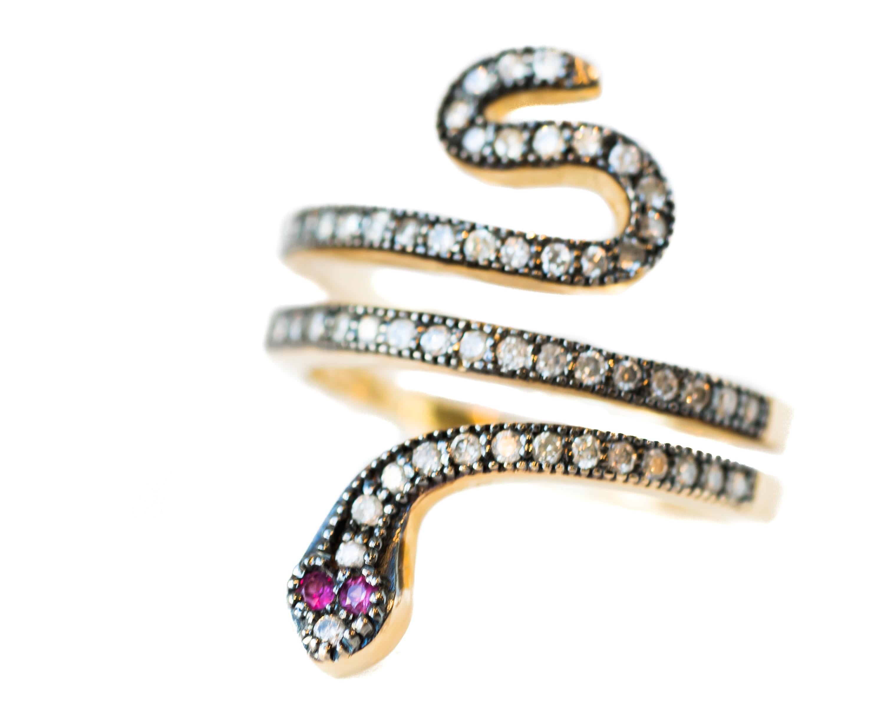 Snake Ring crafted in 14 karat Yellow Gold wth Diamonds and Rubies

Features:
0.39 carat total Diamonds, Coils on front of the ring are diamond encrusted
0.09 carat total Rubies make up the eyes, quantity 2
Crafted in 14 karat Yellow Gold