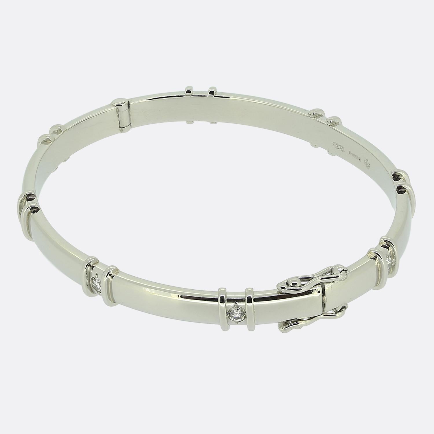 Here we have a contemporary diamond set bangle. This oval bangle plays host to 0.40 carats of round brilliant cut diamonds which have been rub-over set in a solid platinum setting. The bangle also has two safety catches for added security when