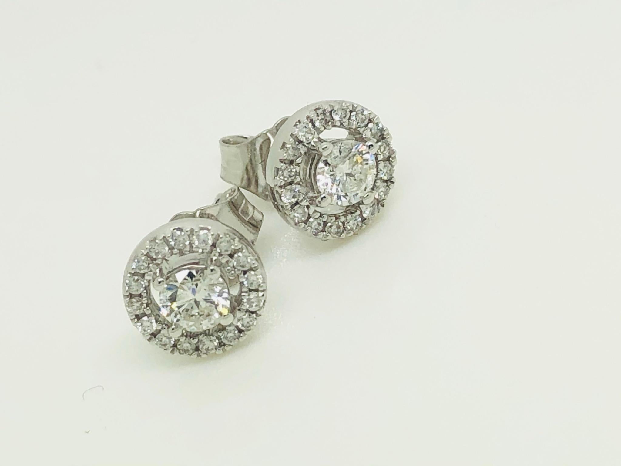 Elegant and eye catching 0.40 Carat Halo Solitaire Cluster earrings set with white colour G and an eye clean clarity SI round brilliant cut diamonds made with 18 Karat White Gold. Available in yellow and rose gold on request, butterfly and post for