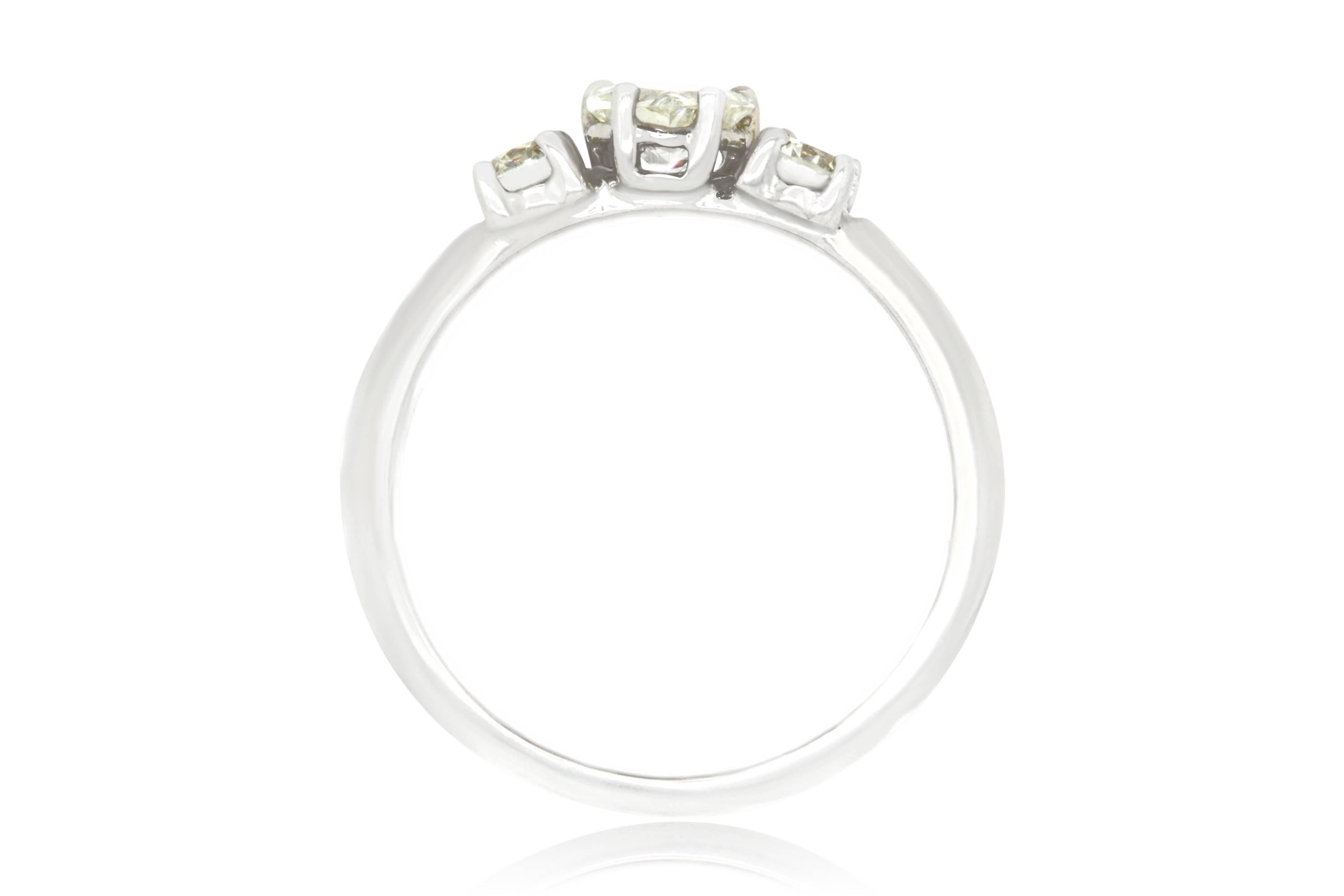 This three-stone diamond ring is just the sweetest dainty diamond ring you can image.  A 0.40 Carat heart shaped White Diamond is bookended by two round White Diamonds at 0.31 Carats.  

Material: 14k White Gold 
Center Stone Details: 0.41 Carat