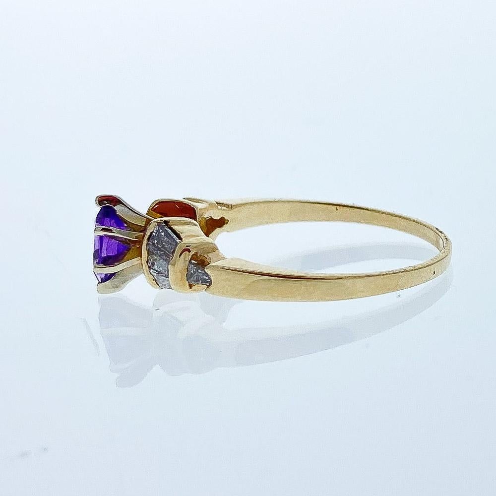 Perfect for those who love to be seen in the color purple! Designed in brightly polished 14 karat yellow gold, this gorgeous cocktail birthstone ring features one deep rich purple amethyst prong set in the center with a weight of 0.40 carats. The