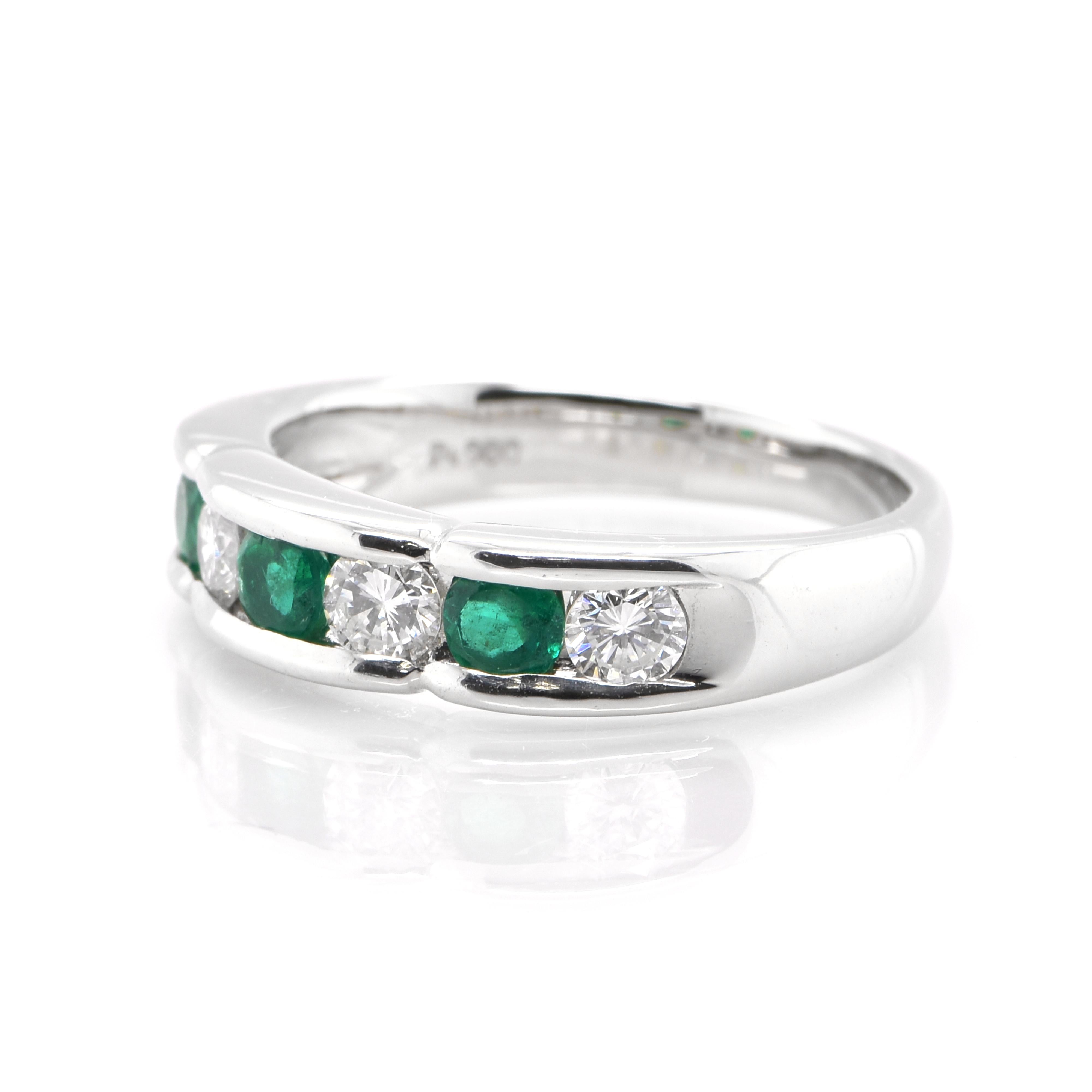 A stunning Band ring featuring 0.40 Carats of Natural Emeralds and 0.50 Carats of Diamond Accents set in Platinum. The Emeralds displays very good color and clarity which is rare for most Emeralds set in jewelry! The ring is great for everyday use