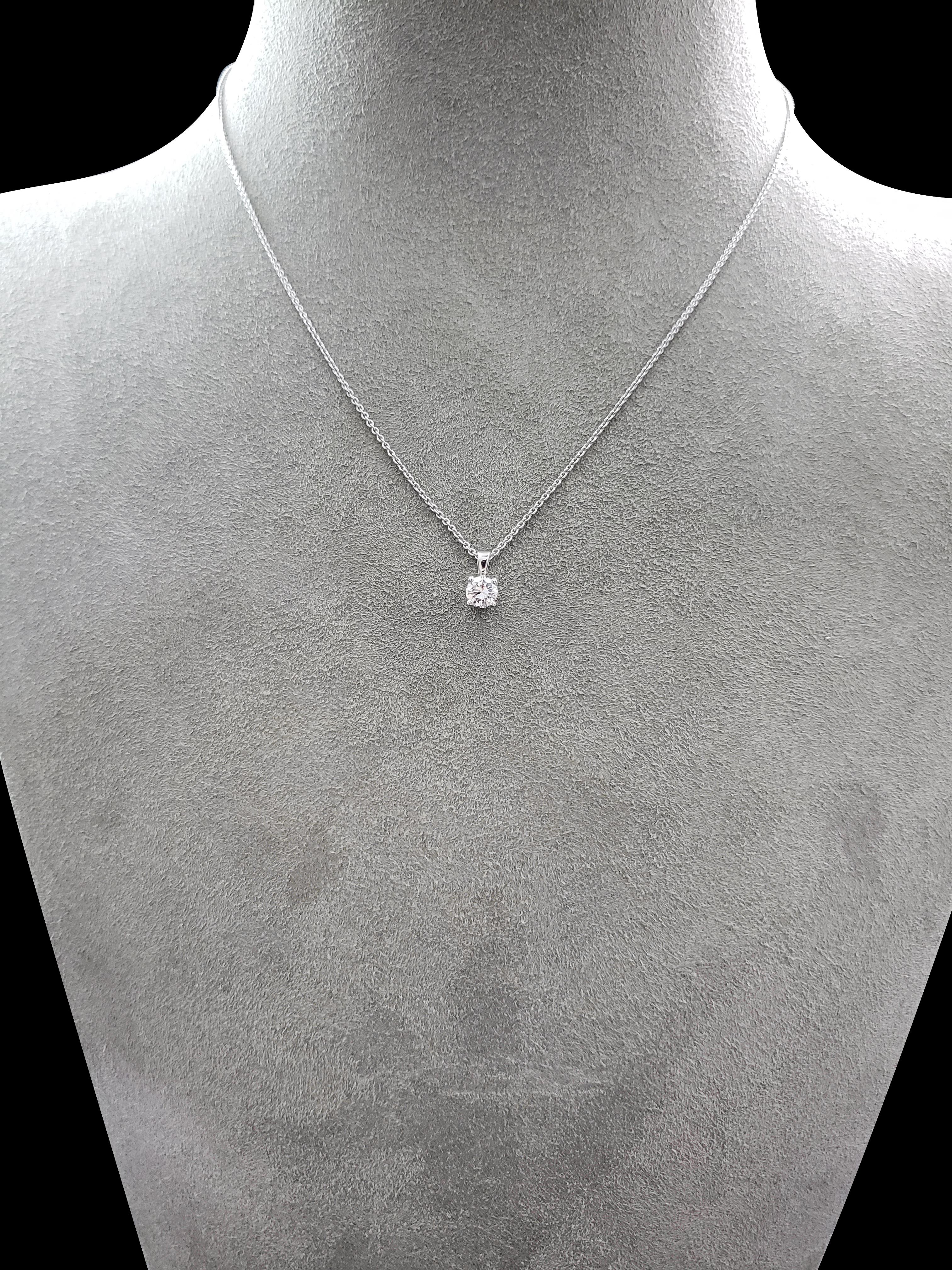A simple and timeless 18 karat white gold pendant showcasing a single 0.40 carat round brilliant diamond in a 4 prong basket. The diamond is suspended on a standard bale attached to a 16 inch white gold chain (adjustable upon request).

Style