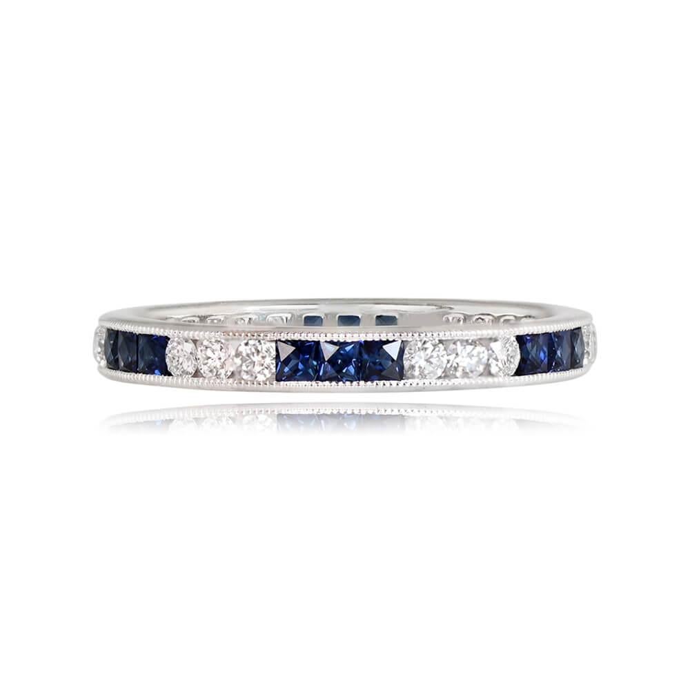 An exquisite diamond and sapphire eternity band crafted in platinum, showcasing 0.40 carats of round brilliant cut diamonds and 0.77 carats of French-cut natural sapphires. The stones are channel-set, and the band is meticulously handcrafted with