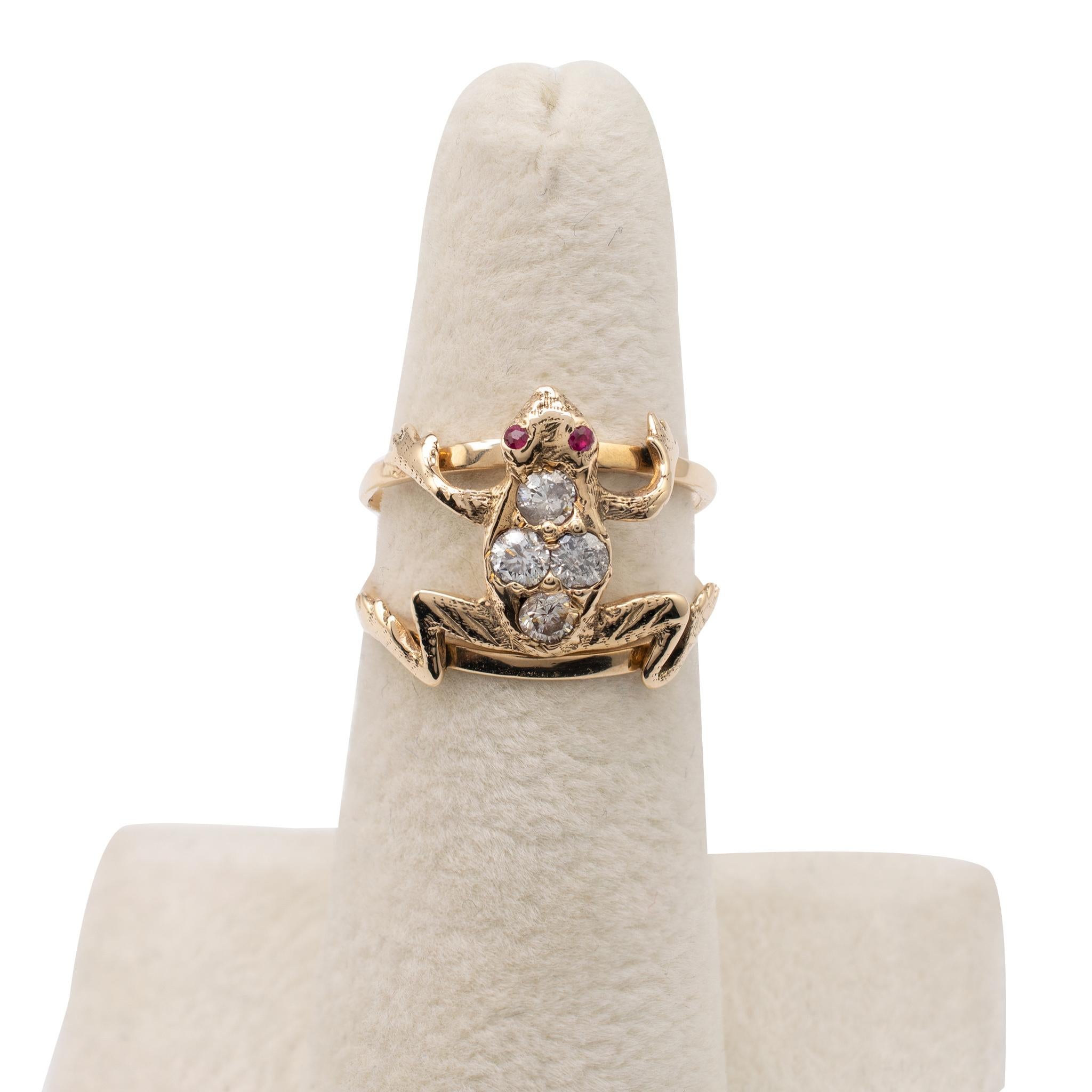 Diamond & ruby frog ring modeled in 15 karat gold.

The frog is realistically modeled and positioned and supported on a split open band. It is set with 4 round-cut 0.10ct diamonds in a quatrefoil arrangement to its back with complimenting rich