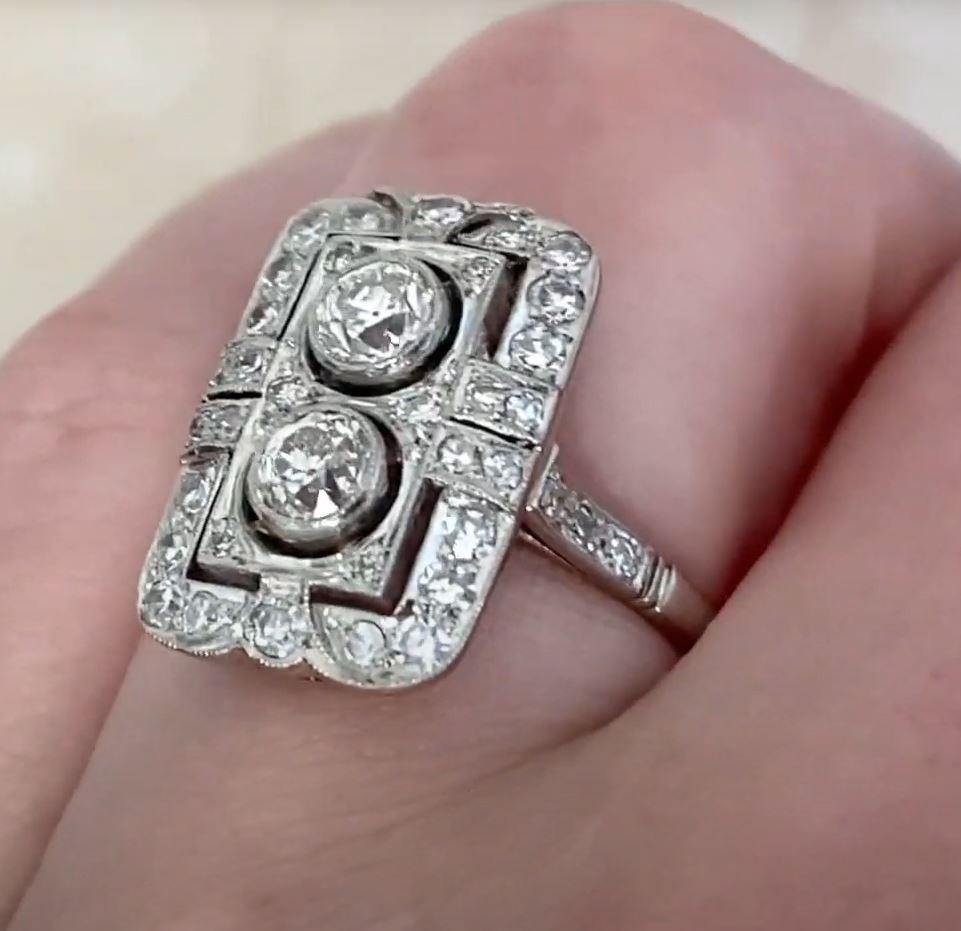 This exquisite elongated two-stone diamond engagement ring showcases a striking north-south design, emphasizing its timeless beauty and sophistication. The two center diamonds, boasting a combined weight of approximately 0.4-carats, exhibit an I