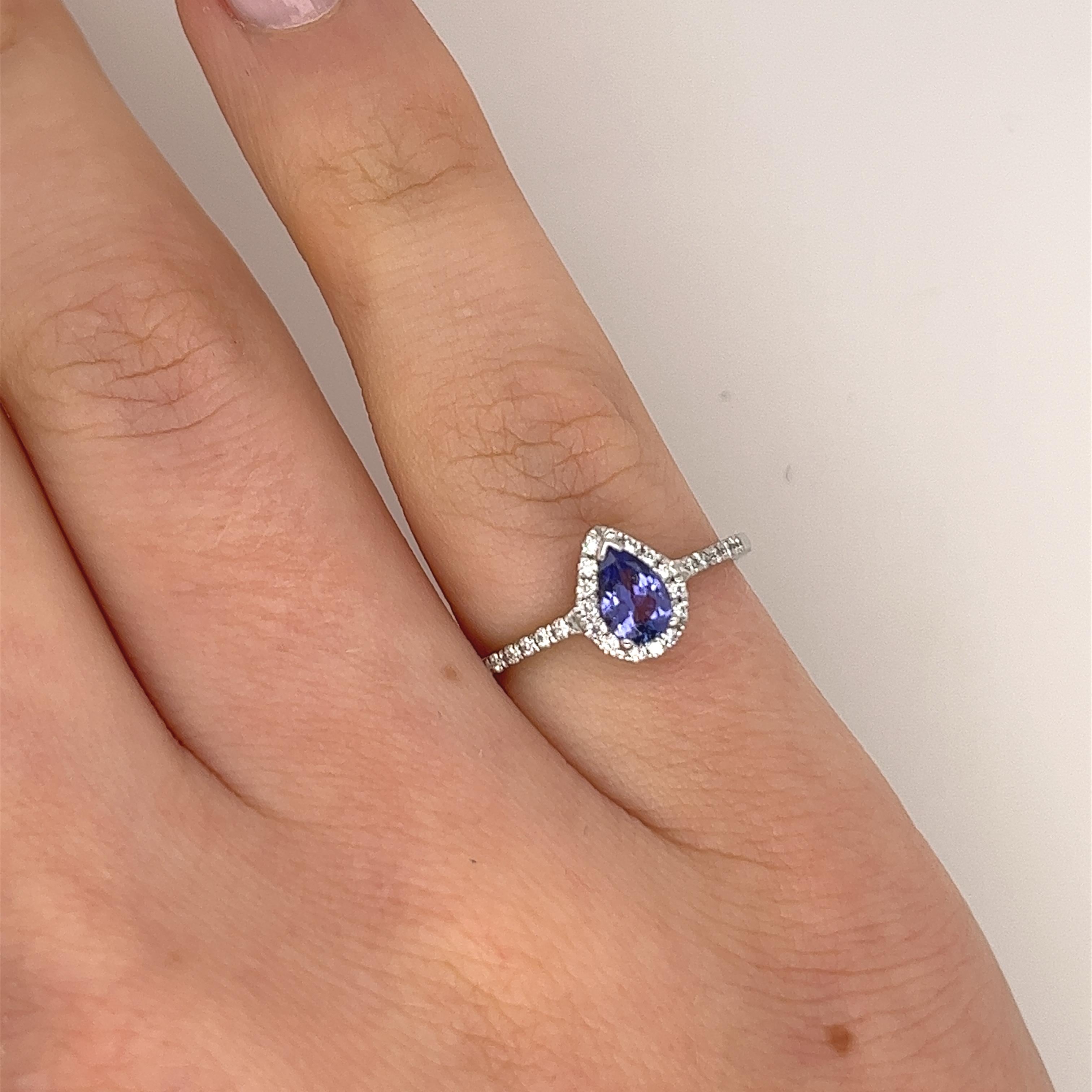 Tanzanite and diamond ring set with 0.40ct pear shape tanzanite and small diamonds on the halo and shoulders,total diamond weight is 0.15ct set in 18ct white gold setting.

Total Weight: 2.1g
Ring Size: J
Width of Band: 1.3mm
Width of Head: