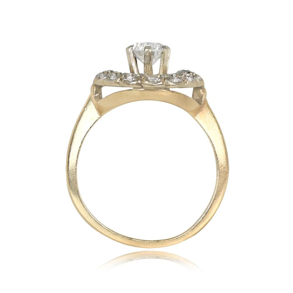 A captivating 14k yellow gold ring with a prong-set round brilliant cut diamond weighing 0.40 carats, H color, and VS1 clarity. The center diamond is encircled by intricate openwork filigree and bordered by a halo of additional round brilliant cut