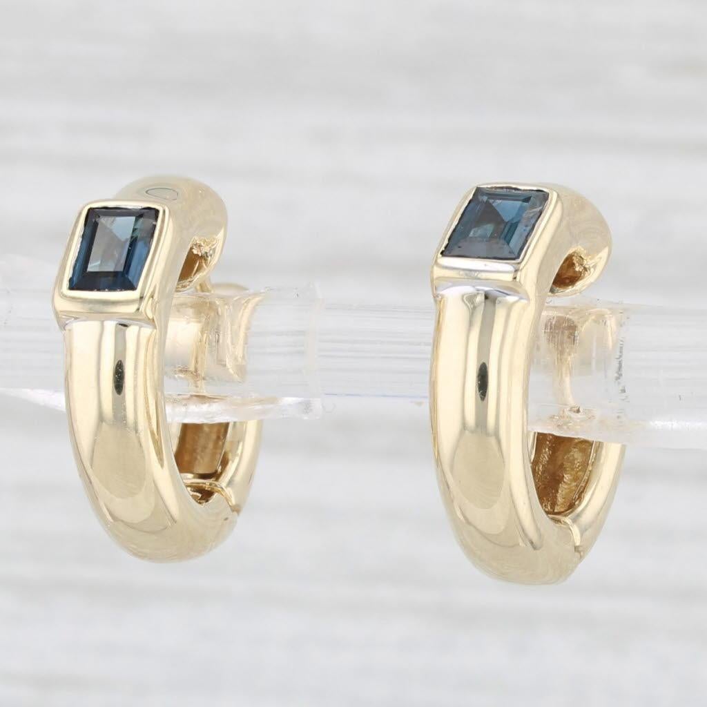 Gemstone Information:
- Natural Sapphires -
Total Carats - 0.40ctw
Cut - Baguette
Color - Dark Blue
Treatment - Heated

Metal: 14k Yellow Gold
Weight: 5.4 Grams 
Stamps: 14k 
Closure: Hinged with snap top posts
Measurements: 15.1 x 4.3 mm
