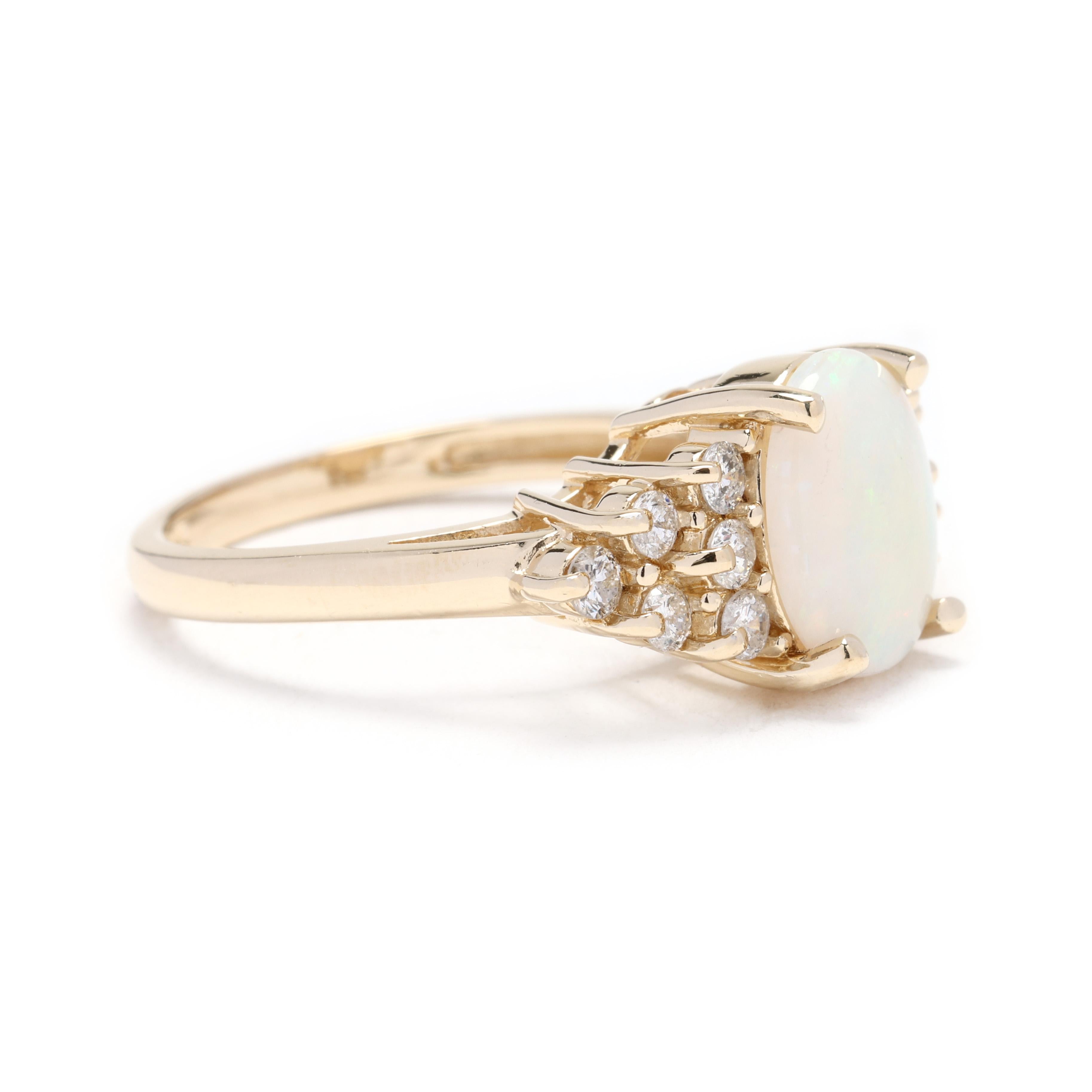 This stunning cluster ring combines the timeless beauty of diamonds with the iridescent allure of opal. Crafted in 14k yellow gold, the ring features a large oval-shaped opal center stone, surrounded by a cluster of diamond gemstones. The opal