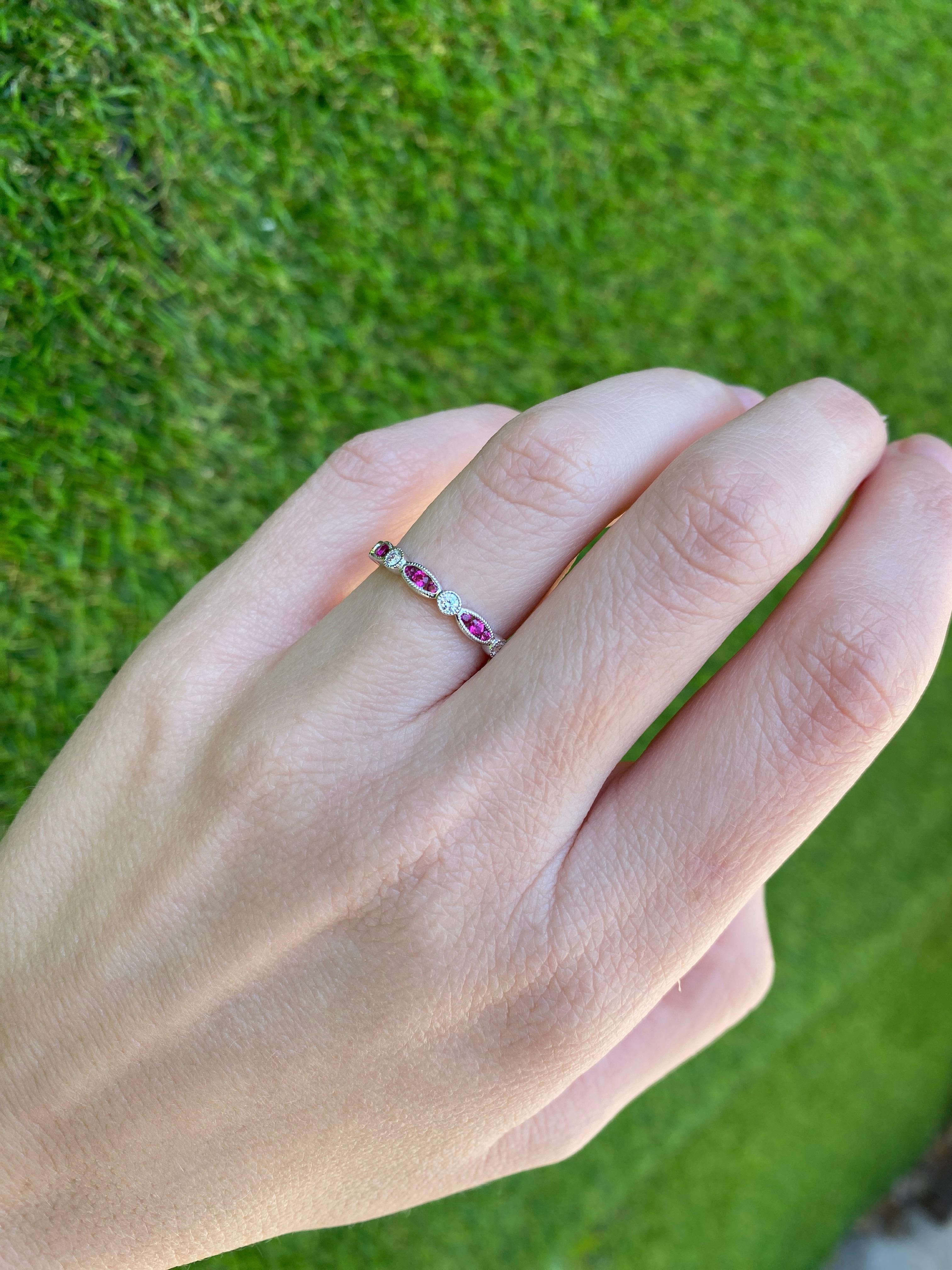 This is the perfect and unique stacking band! It features 0.40 carat total weight in round rubies set in a marquis like shape alternating with 0.17 carat total weight in round diamonds. It is set in 18 karat white gold with milgrain detailing. This