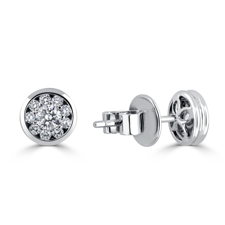 These shining stud earrings feature clusters of 10 round diamonds, set in 18k White Gold. A larger center is encircled by nine smaller bezel set diamonds. Total diamond weight 0.41 carats.
Suggested retail price: $3,356

DiamondTown is pleased to