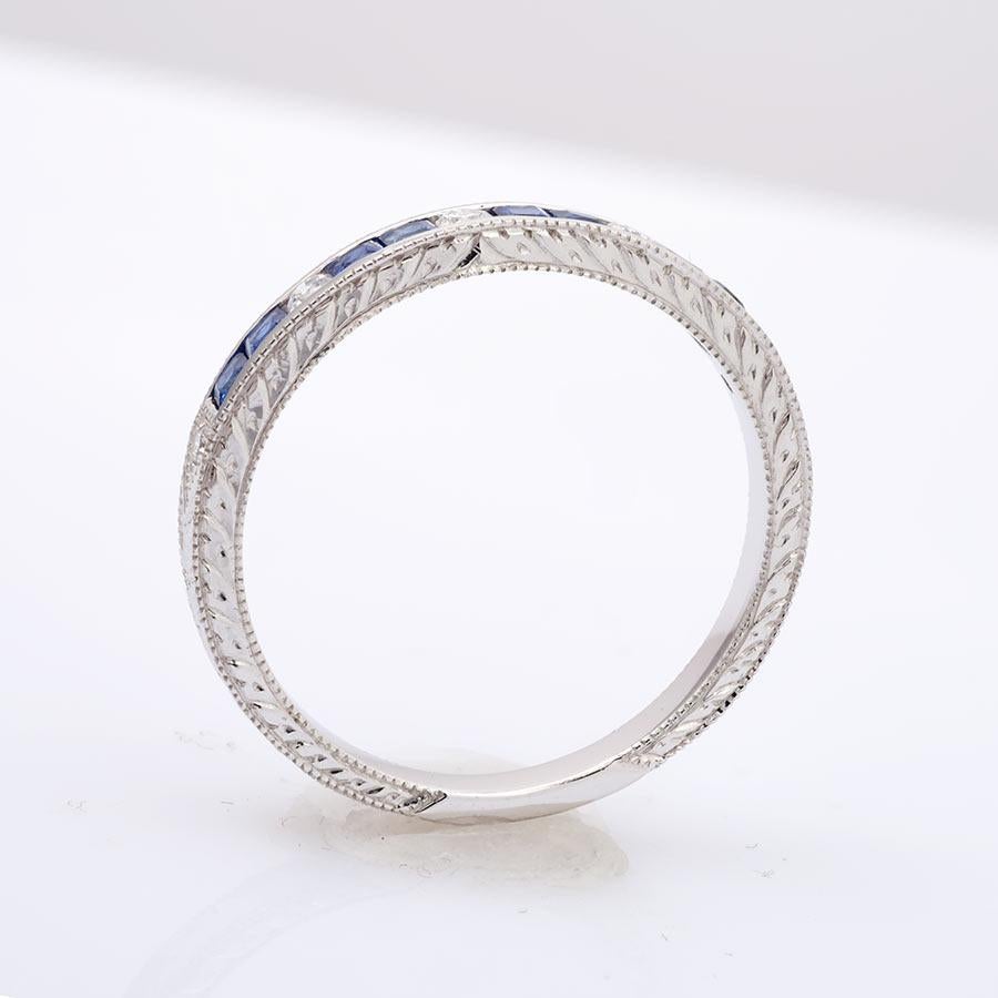 Blue Sapphires with Diamonds are the best combination to tell of an everlasting love. This half eternity band uses both a channel and a pavé setting to secure its gems in place. Set in 18K white gold with 0.41 carats of bold blue Sapphires she won’t
