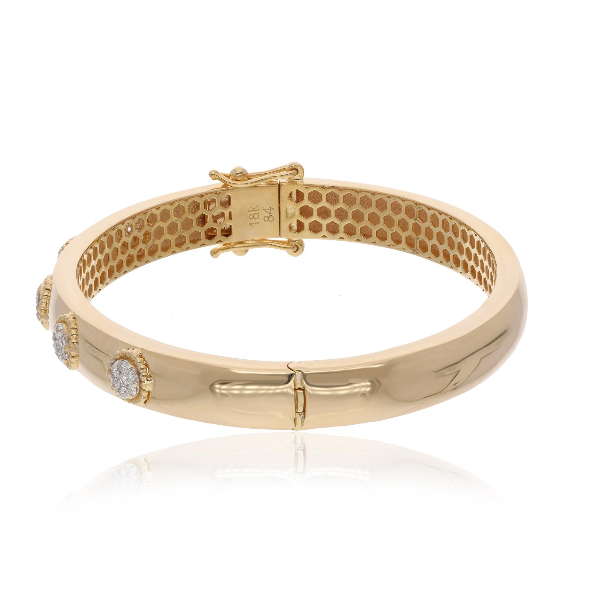 Looking for a stunning piece of jewelry to add to your collection? Look no further than this exquisite Gold Bangle, adorned with a cluster of pave diamonds! The cluster of diamonds is expertly set, creating a dazzling display that catches the light