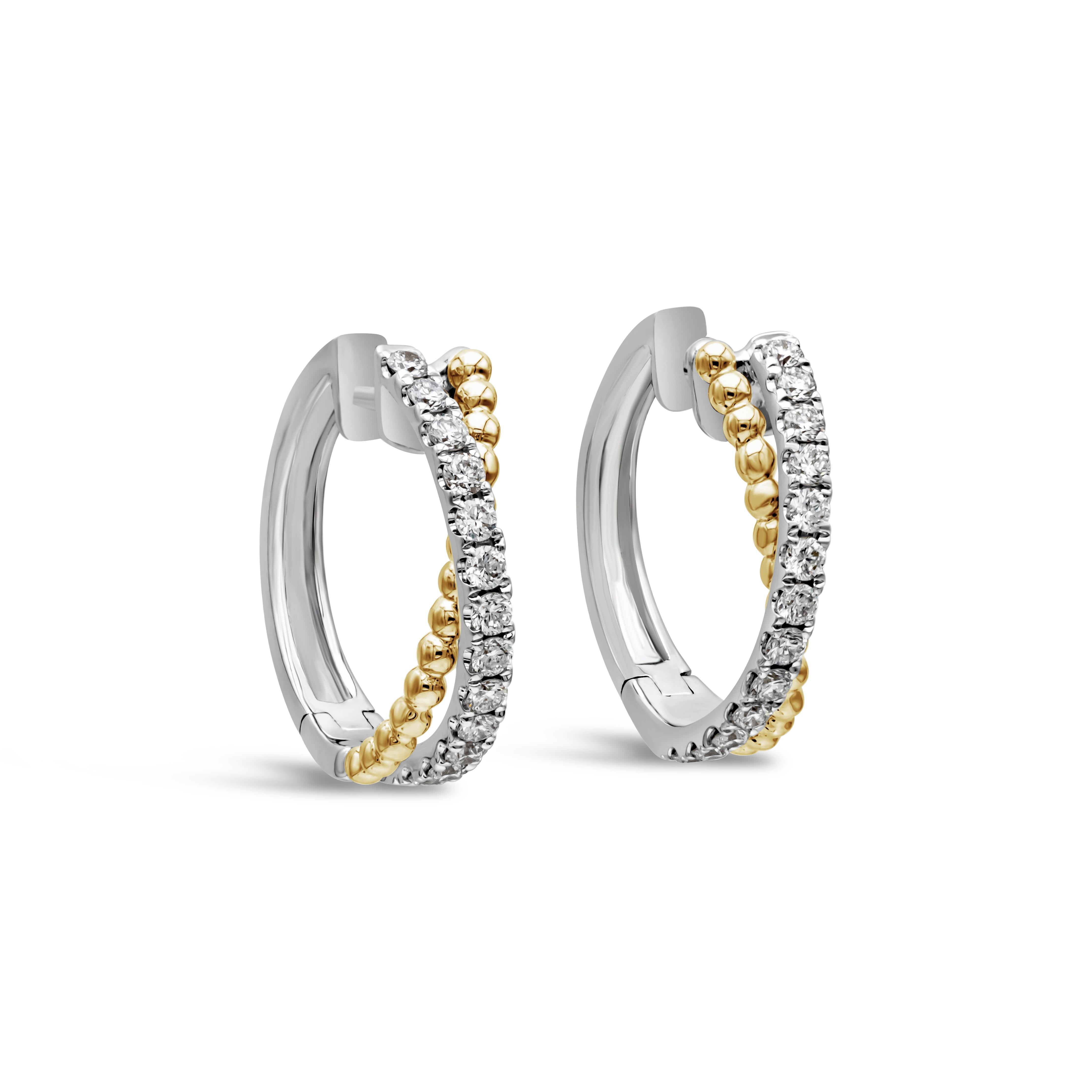 This pair of earrings shows a unique criss-cross design of a row of diamonds and a row of round yellow gold balls. The brilliant round diamonds weigh a total of .42 carats. Mounted in a classic four prong setting, lined up in a row. Earrings made in