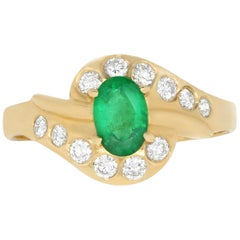 0.42 Carat Oval Emerald and 0.25 Carat White Diamond Ring