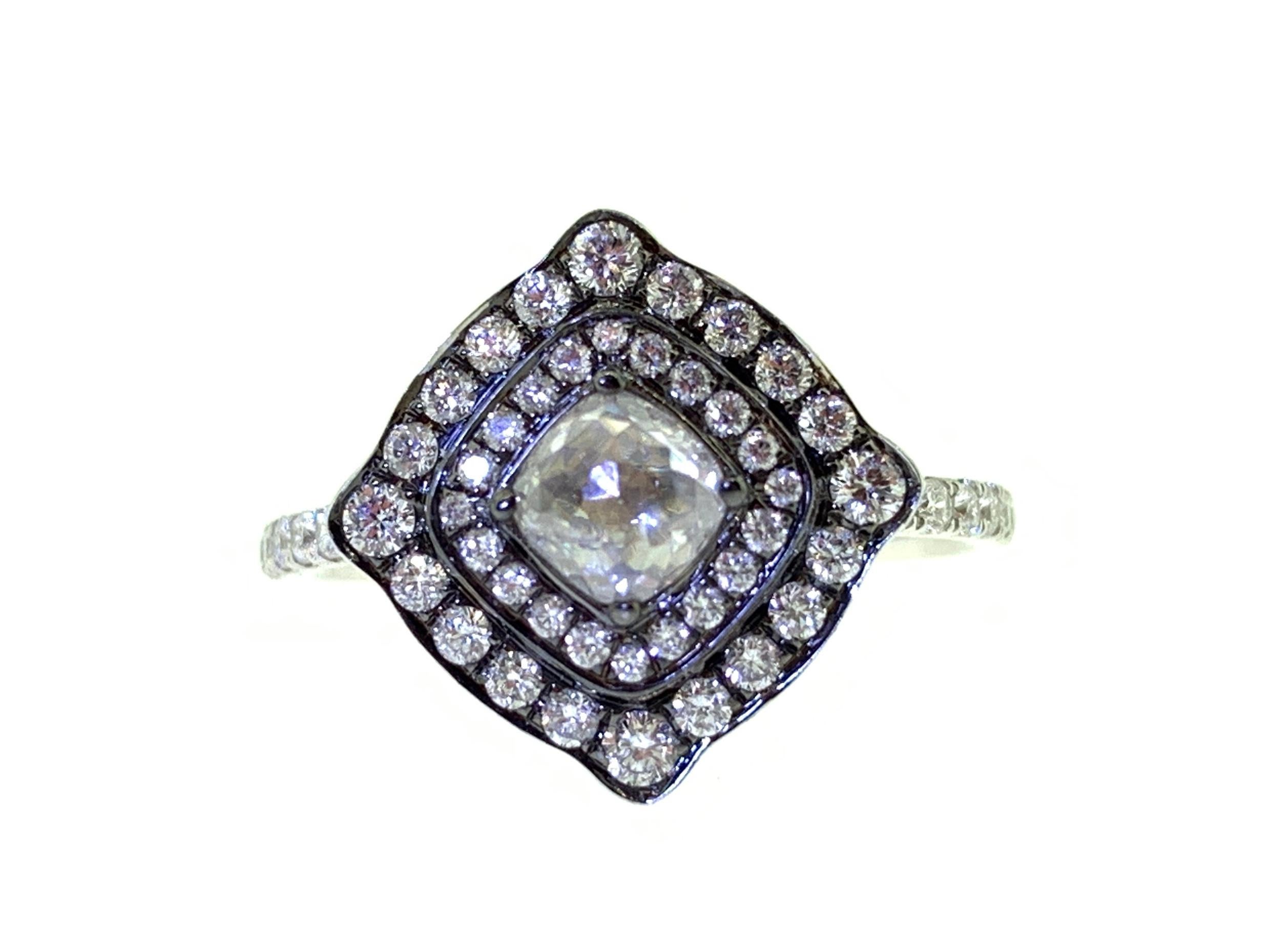 This stunning ring showcases a beautiful 0.42 Carat Rose Cut Cushion Diamond with a Double Diamond Halo on a Diamond Shank. This ring designed in the style of Art Nouveau, and is set in 18k White Gold. Total Diamond Weight (not including center