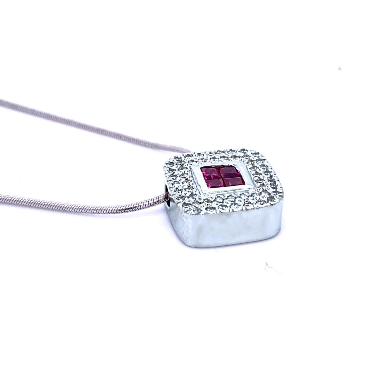 18K Gold Cushion Shape Diagonal Pendant with 4 Invisible Set Princess Cut Rubies (Total Gem Weight 0.46 Ct) surrounded by a pave set Halo of diamonds with total weight of 0.42 Ct. The pendant is set on a 16 inch Snake chain.
Total Diamond Weight: