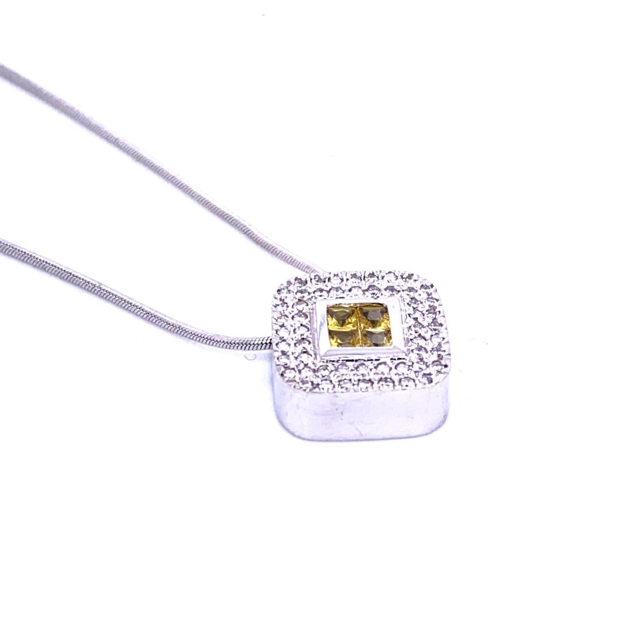 18K Gold Cushion Shape Diagonal Pendant with 4 Invisible Set Princess Cut Yellow Sapphires (Total Gem Weight 0.46 Ct) surrounded by a pave set Halo of diamonds with total weight of 0.42 Ct. The pendant is set on a 16 inch Snake chain.
Total Diamond